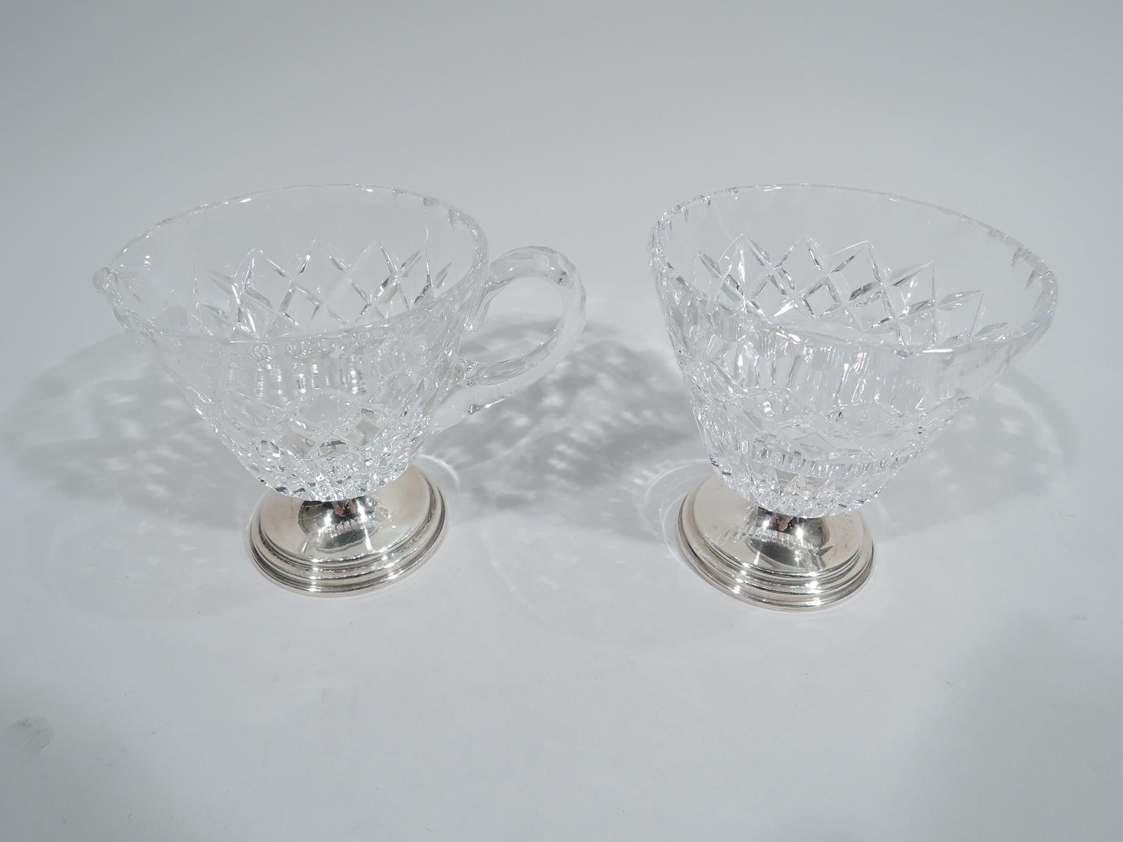 Mid-Century Modern sterling silver and cut-glass creamer and sugar. Made by Hawkes in Corning, New York. Each: Conical bowl on flutes and diaper, and scalloped rim border. Creamer has c-scroll handle and small u-form spout. Stepped and round