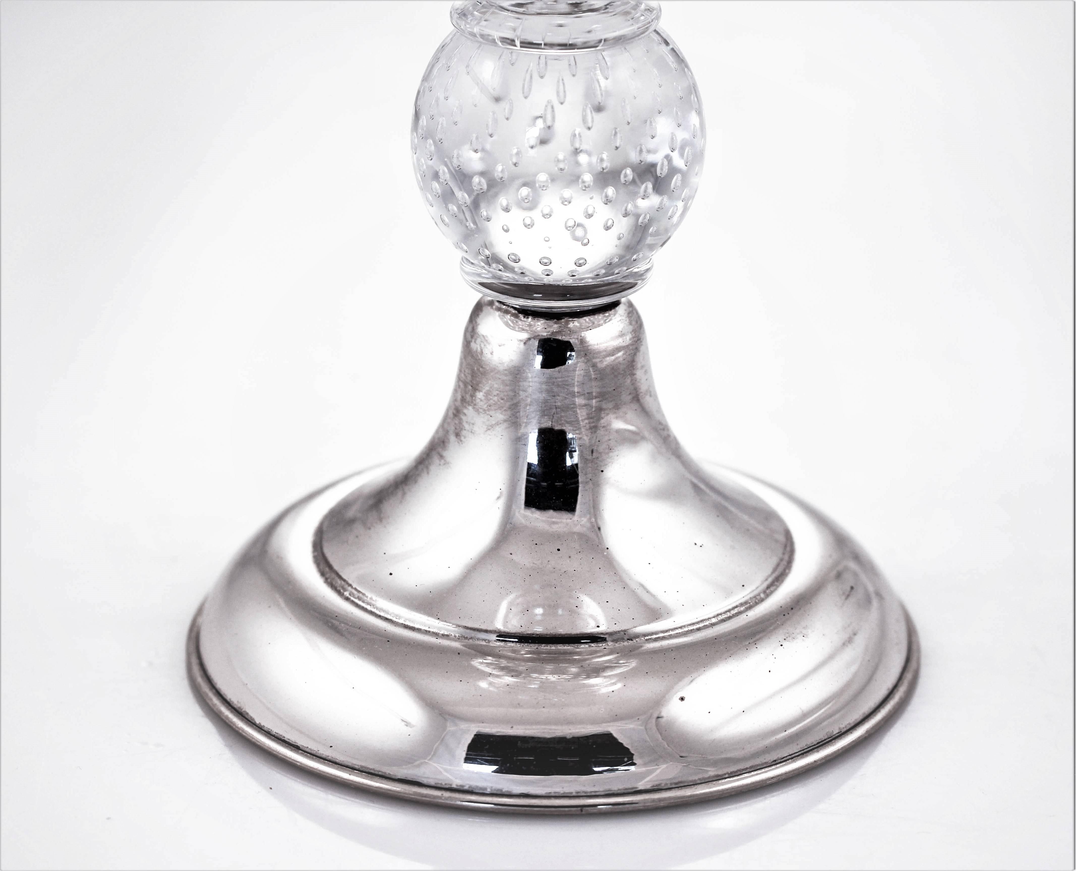 The combination of silver and crystal is just stunning! Look at the cut-glass; flowers and leaves. There is also a row of oval shaped design that comes down on two sides and drapes the bottom. Just above the sterling base, a tennis-ball sized