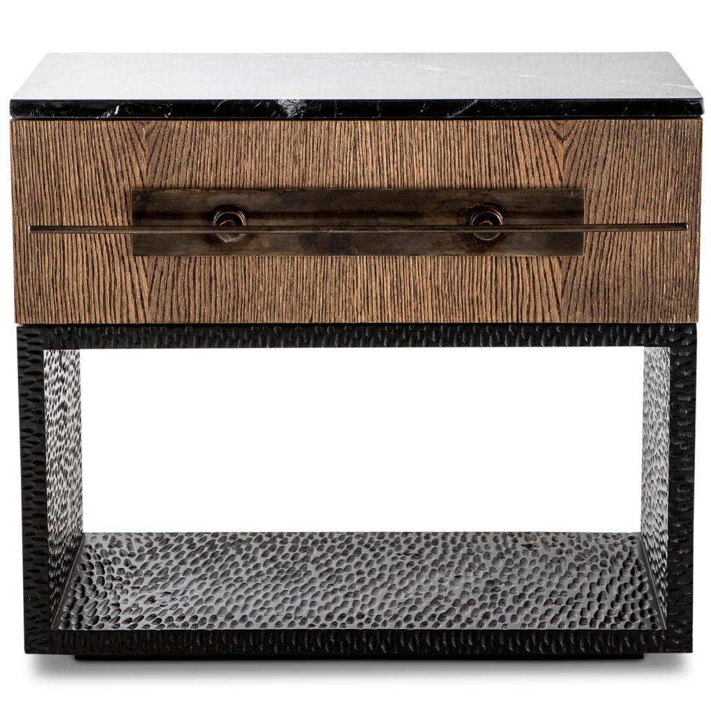 The Hawkstone modern bedside pedestal sits on a hand chiseled, alien timber, base which is burnished black. On top of the base is a fumed oak drawer unit on soft close hinges. The drawer has a custom design bronzed steel handle and a Nero Marquina