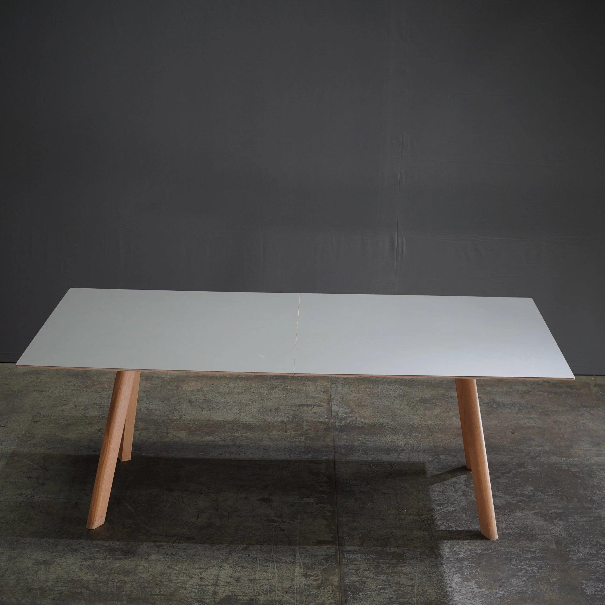 Experience the seamless blend of minimalist Scandinavian design with the Hay CPH 30 Copenhague White Dining Table, crafted by the renowned design duo Ronan & Erwan Bouroullec. With its clean lines and functional elegance, this table features a