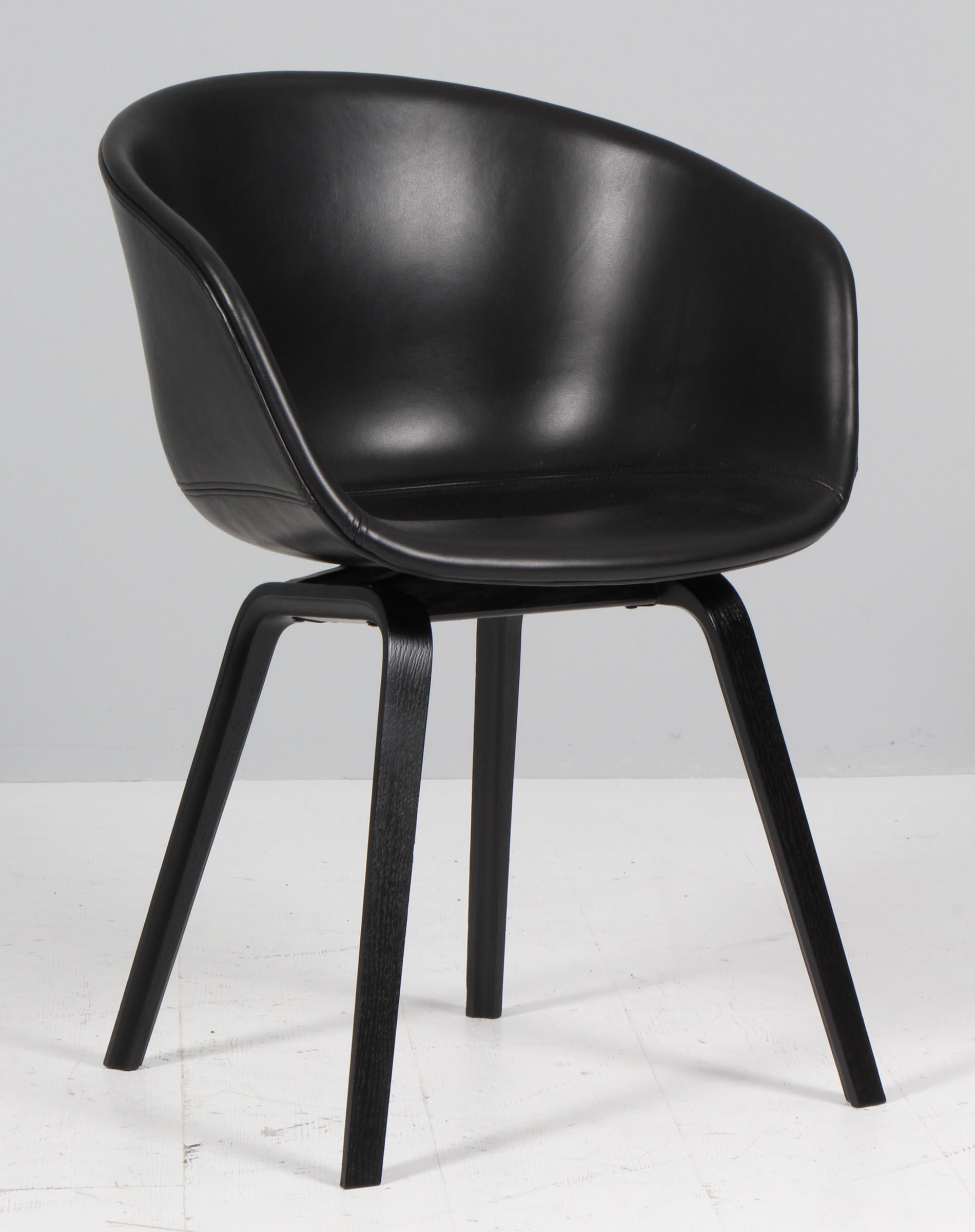 Hay AAC22 dining chairs in black silk full grain aniline leather with black stained ash legs. 