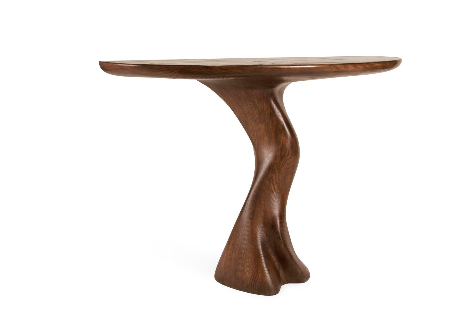 Haya console table is a stylish futuristic sculptural art table with a organic form designed and manufactured by Amorph. Haya console table is made out of solid wood and stained. 

It is available in different finishes and custom sizes. 

About