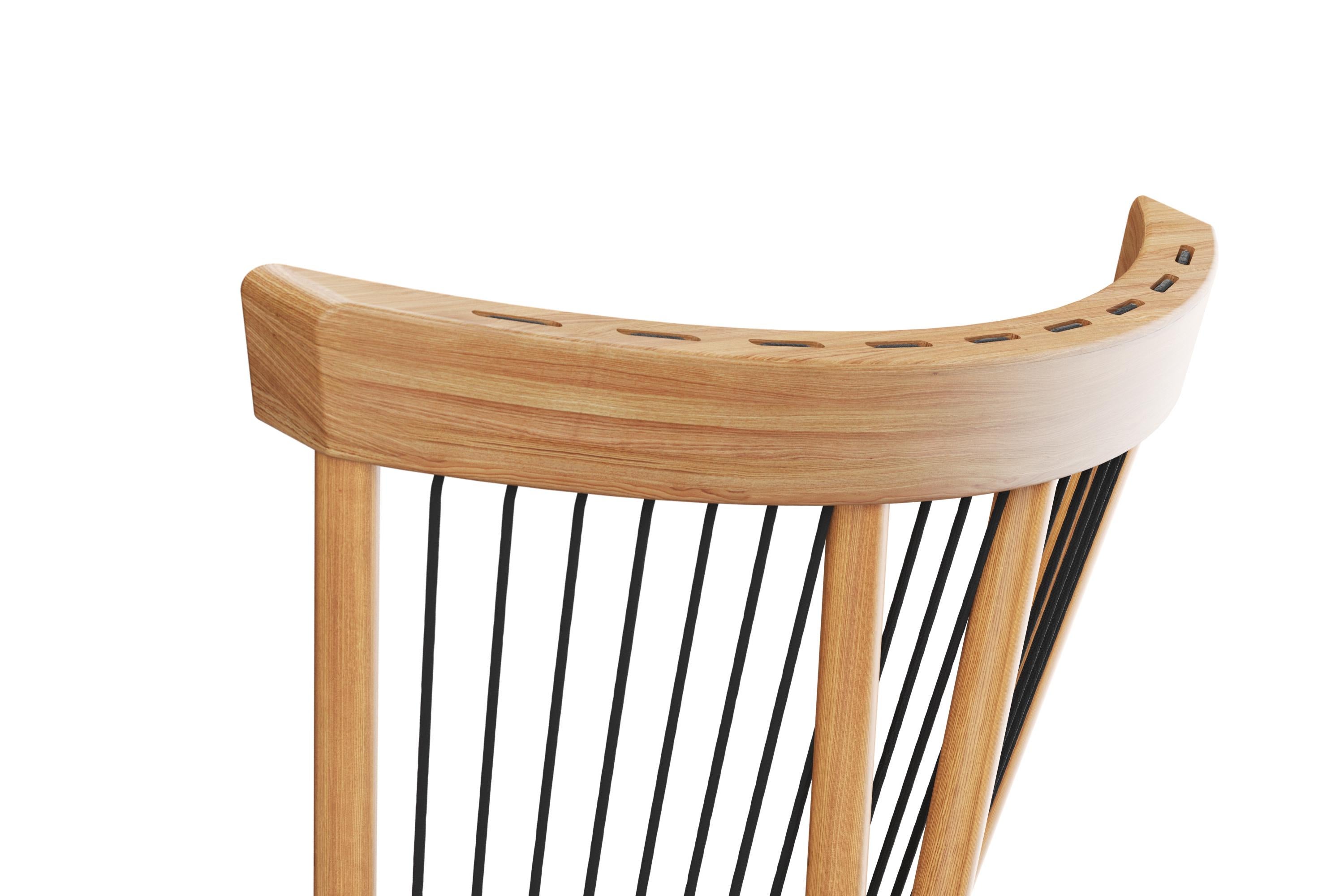 The Cuerdas Chair artfully reinterprets the classic Windsor chair, incorporating the warmth of solid oak with the distinctive touch of woven cords. In this innovative design, the wooden backrest is supported by four robust 22mm solid wood