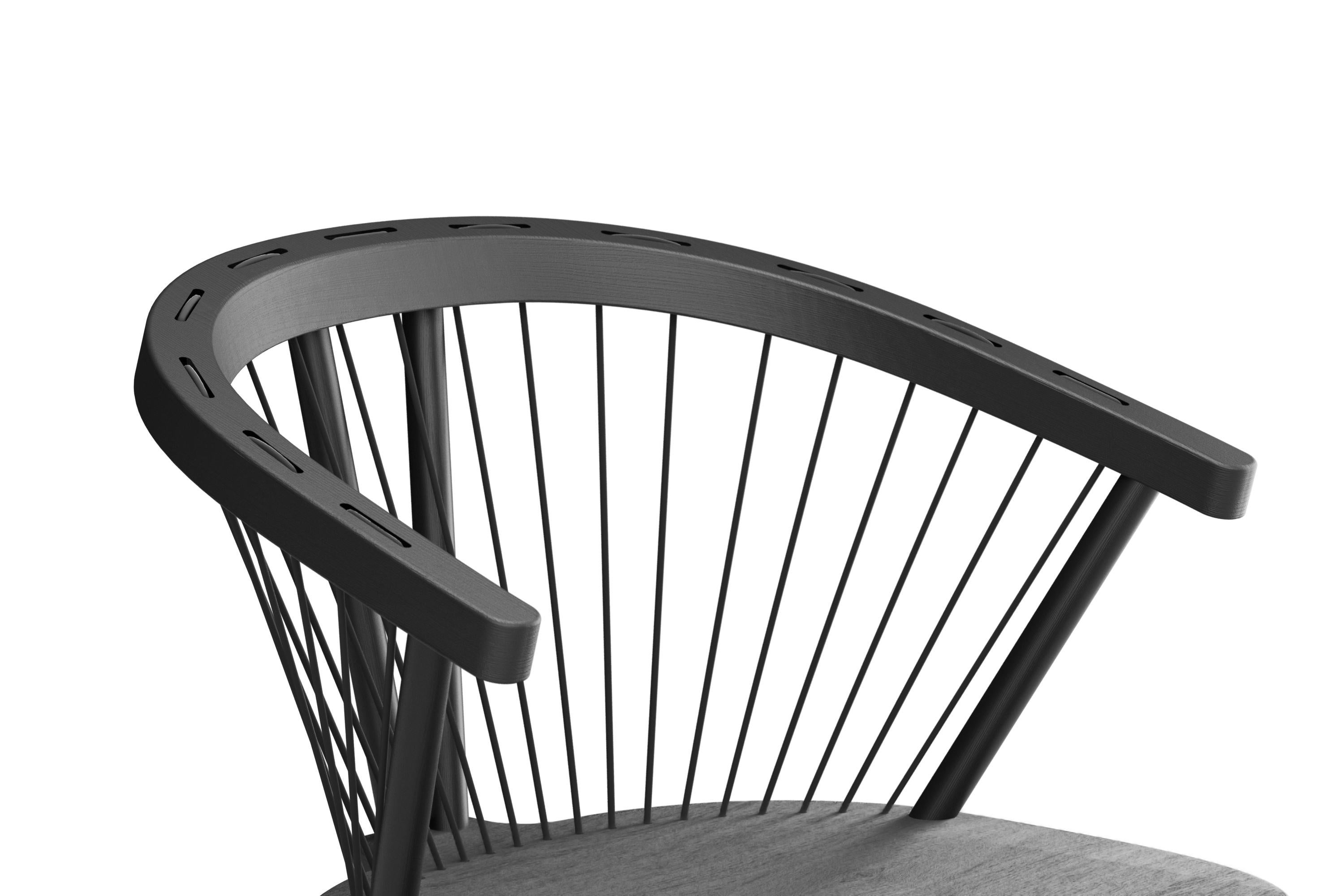The Cuerdas Rounded Chair offers a fresh take on the classic Windsor chair, seamlessly blending solid oak with the unique element of woven cords. Named 