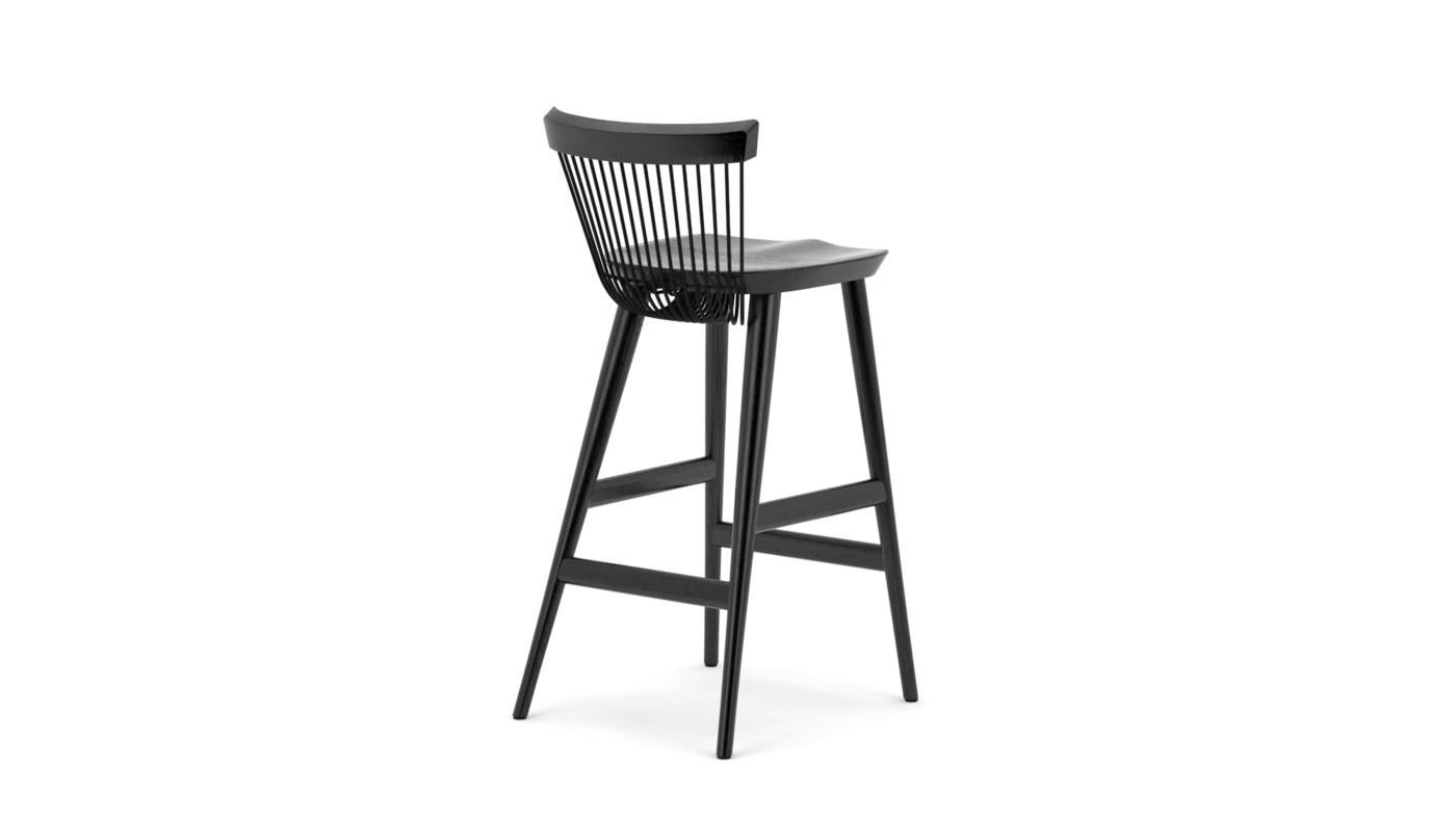 Based on a modern Windsor design, the WW bar stool, where the first 'W' stands for Windsor and the second for Wire is an iconic piece of furniture. Produced from solid oak with the unique 'wire' backrest formed from mild steel rods which are