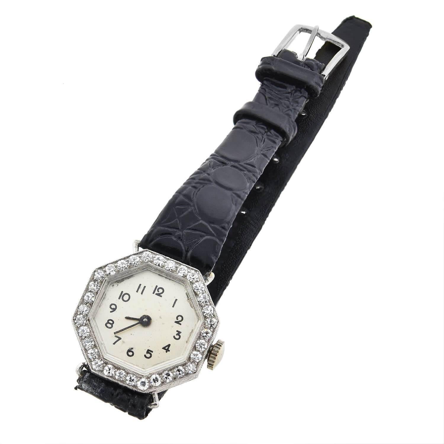 A very stylish platinum and diamond watch from the Art Deco (ca1920s) era! This stunning timepiece features a flat octagonal face set in a sleek platinum encasement. Sparkling diamonds line the uniquely shaped face, each micro-prong set within the