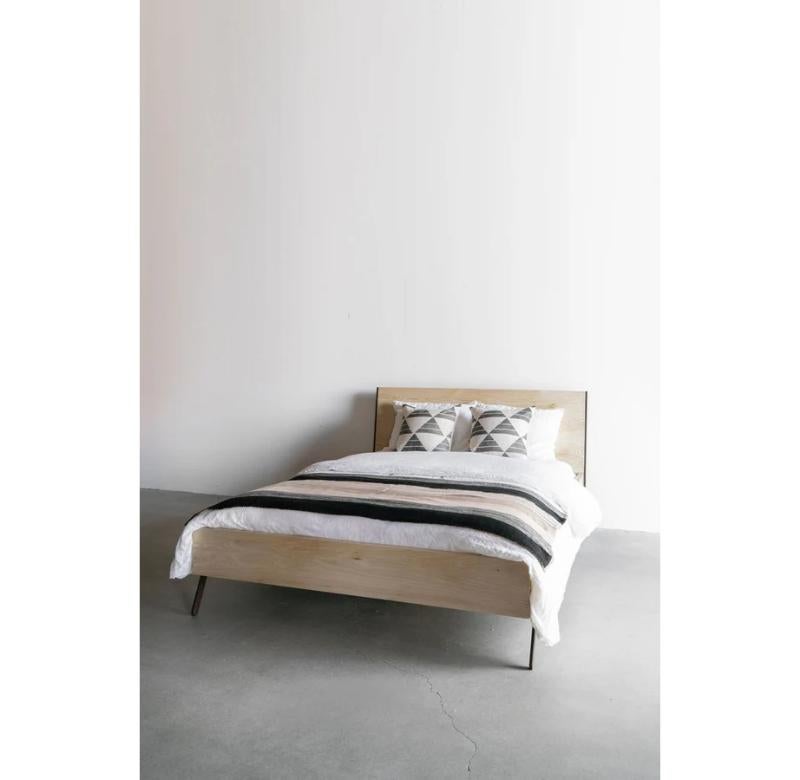 The Hayes Bed from blends contemporary design with timeless materials. Crafted from bleached oak and accented with antique bronze patinated steel trim and legs, this bed complements a range of interior styles and decor. Its clean lines and hard