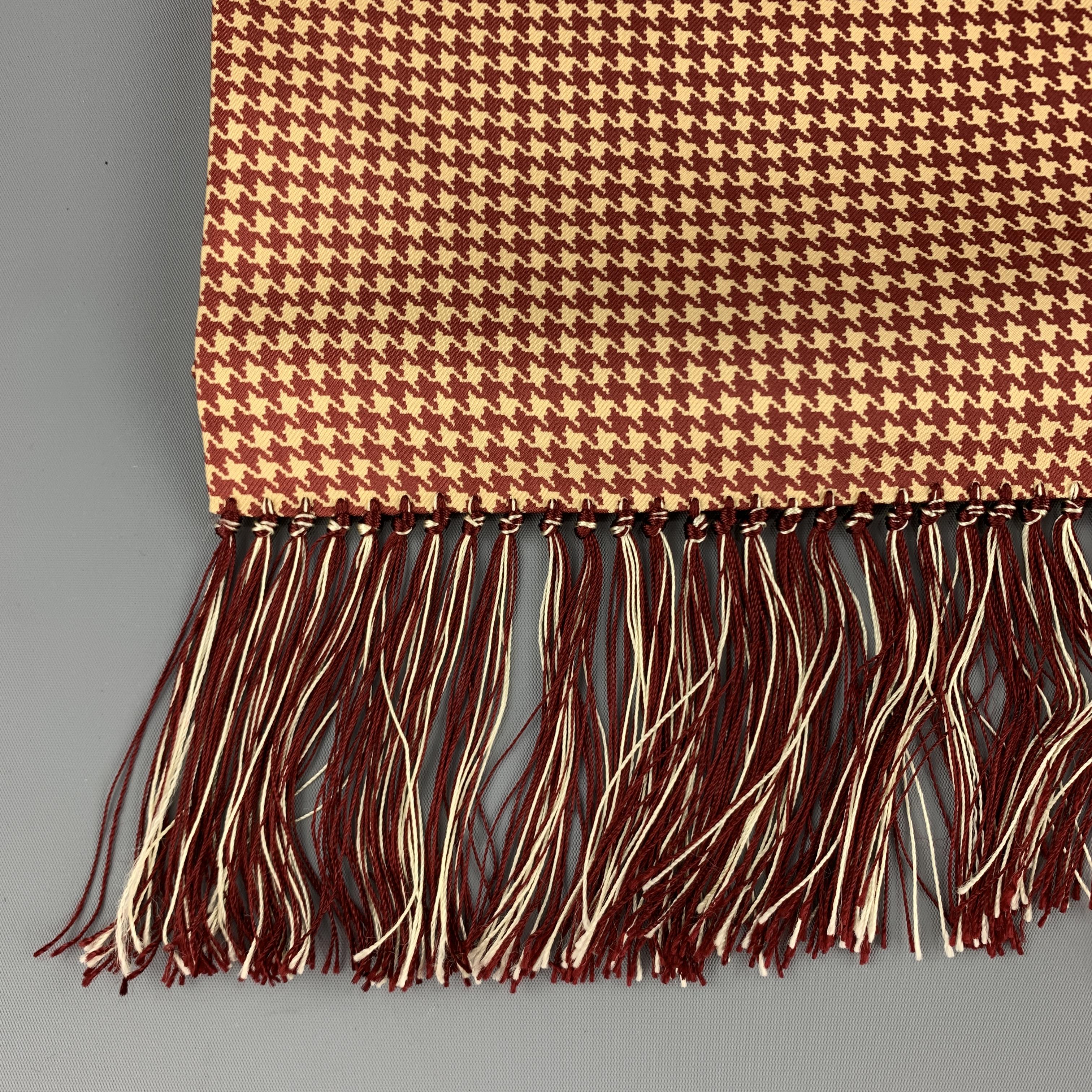 HAYWARD LONDON scarf comes in burgundy and beige houndstooth print silk twill four inch fringe trim. Made in England.

Excellent Pre-Owned Condition.

57.5 x 19.5 in.