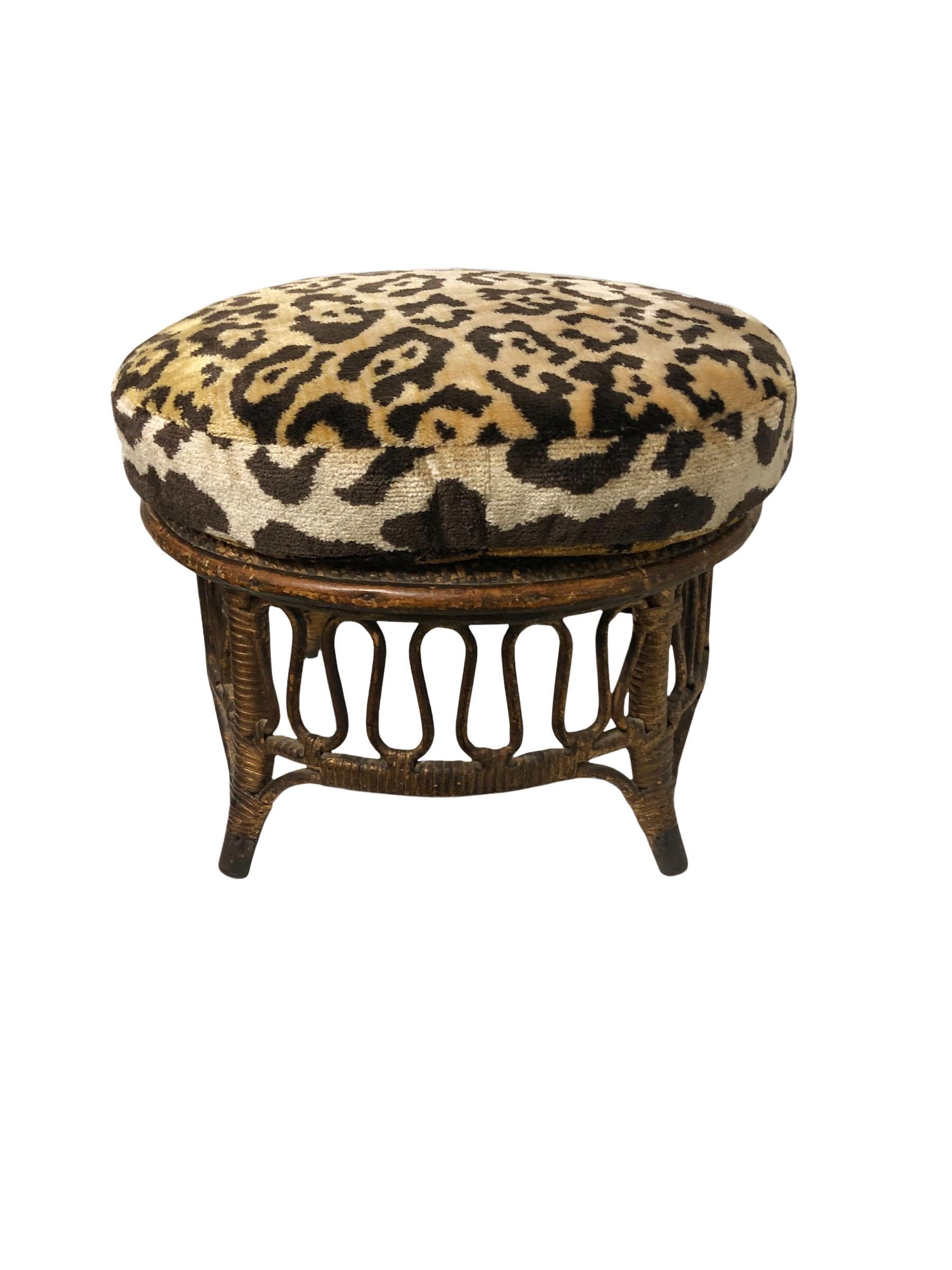 Haywood Wakefield turn of the century or maybe a little older. The stool has been reupholstered in silk tiger velvet. It is made out of wood and rattan with little metal feet the zigzags are wood. Has original paper label.