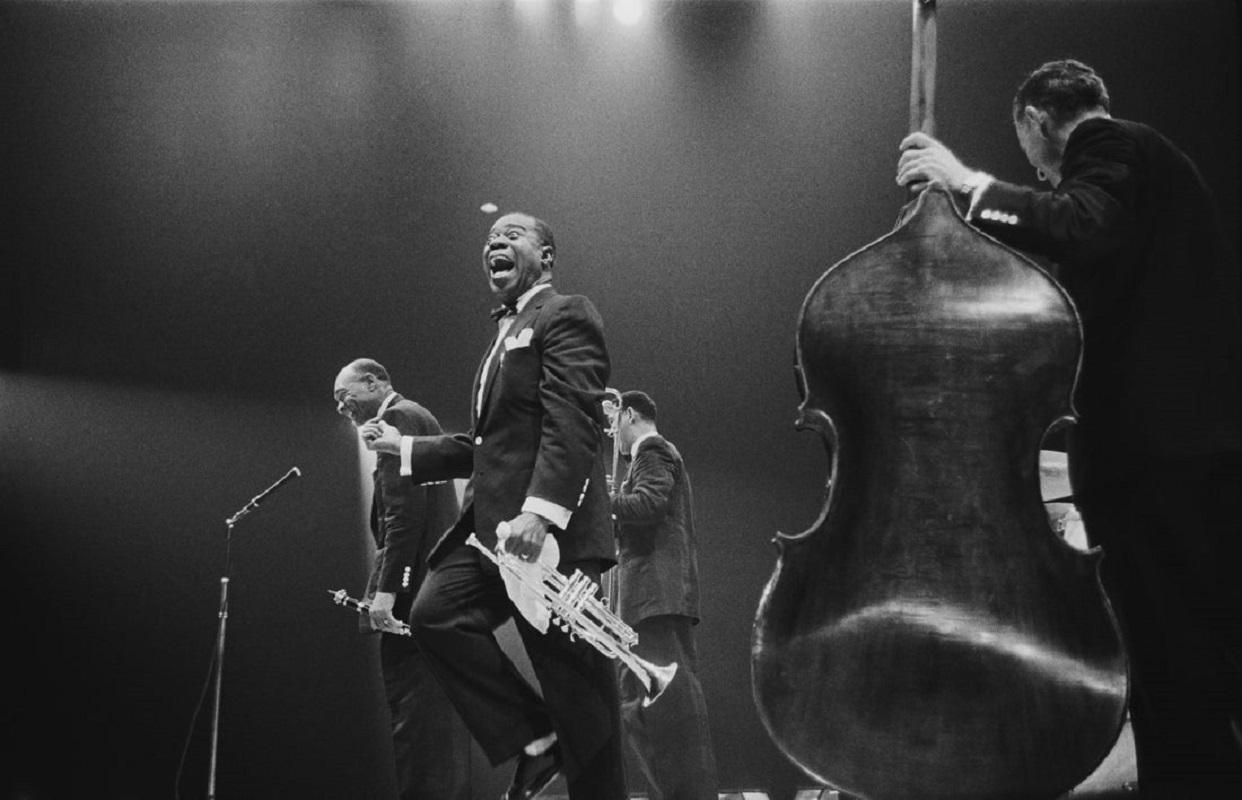 "Louis Armstrong On Stage" by Haywood Magee

American jazz trumpeter and bandleader Louis 'Satchmo' Armstrong (1900 - 1971), shouts after clarinettist Edmund Hall's solo, on stage during the band's British tour, May 19, 1956. An unidentified bassist