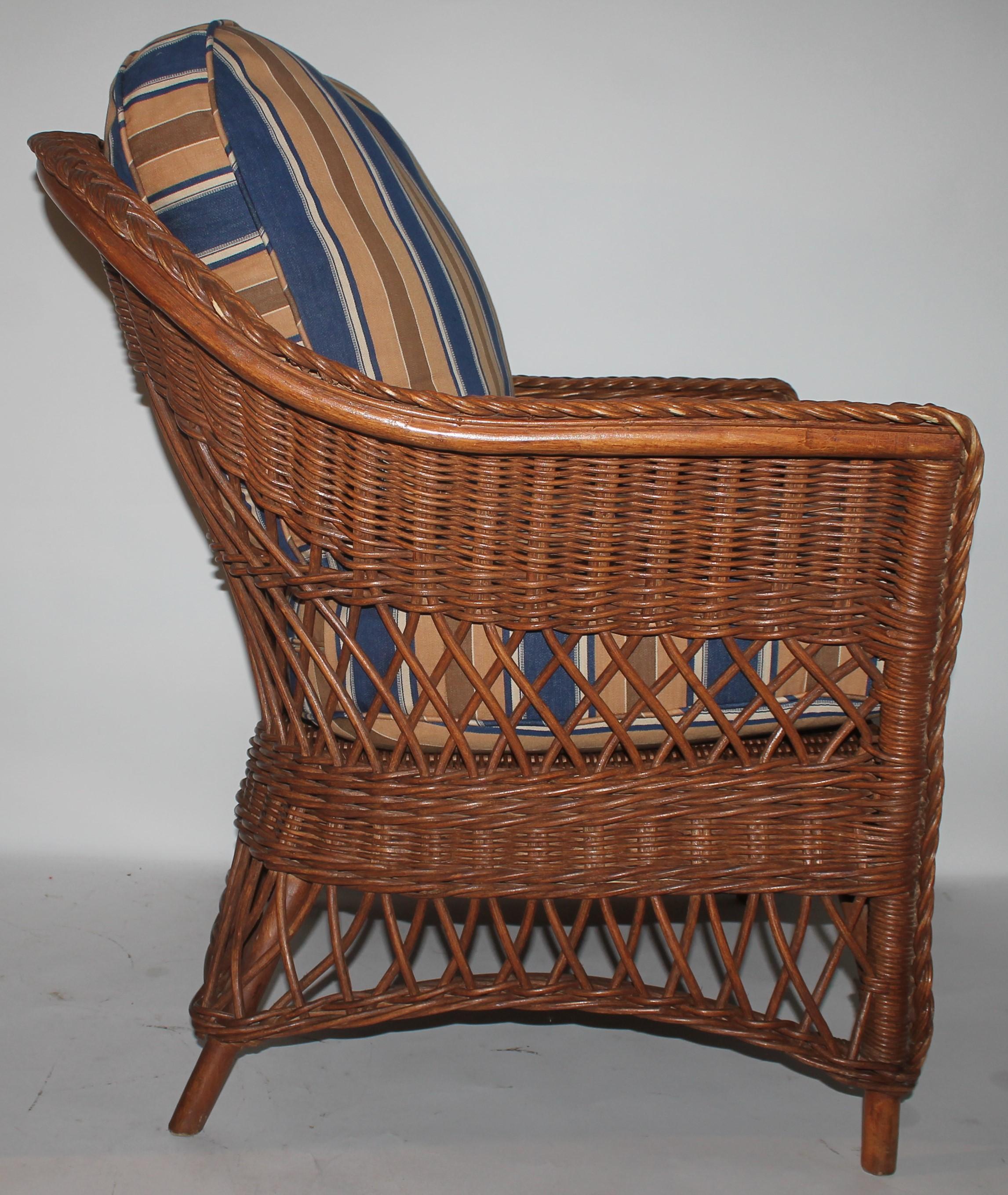 Early 20th century Haywood Wakefield wicker side chair with custom made vintage ticking cushions. The inserts are down and feather fill and can be removed for cleaning.