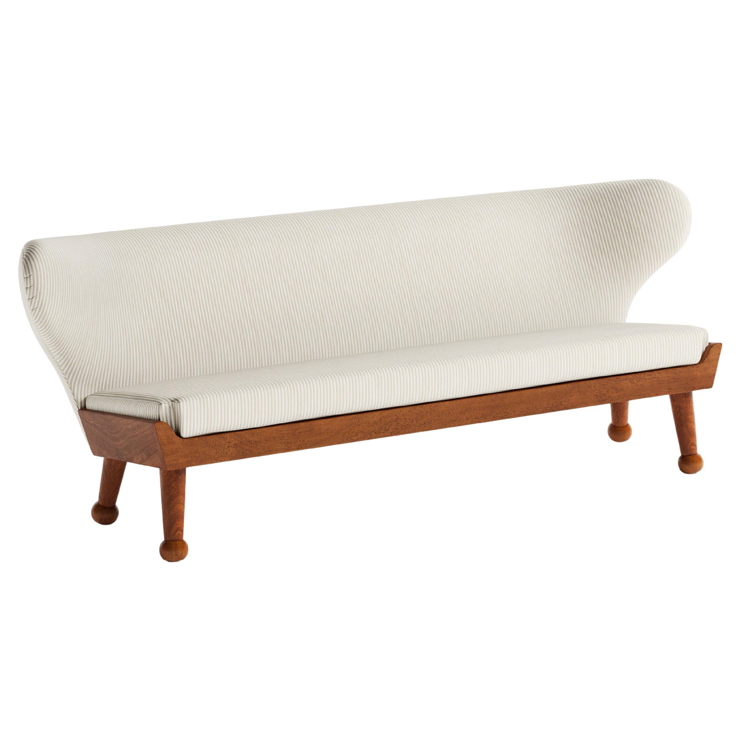 Our winged Hayworth Sofa, with low-profile design, is the newest addition to our Hayworth Collection. Bench made in Los Angeles, its soft curves pair with a sturdy foundation of Iroko wood in this indoor-outdoor piece created to embrace spirit of