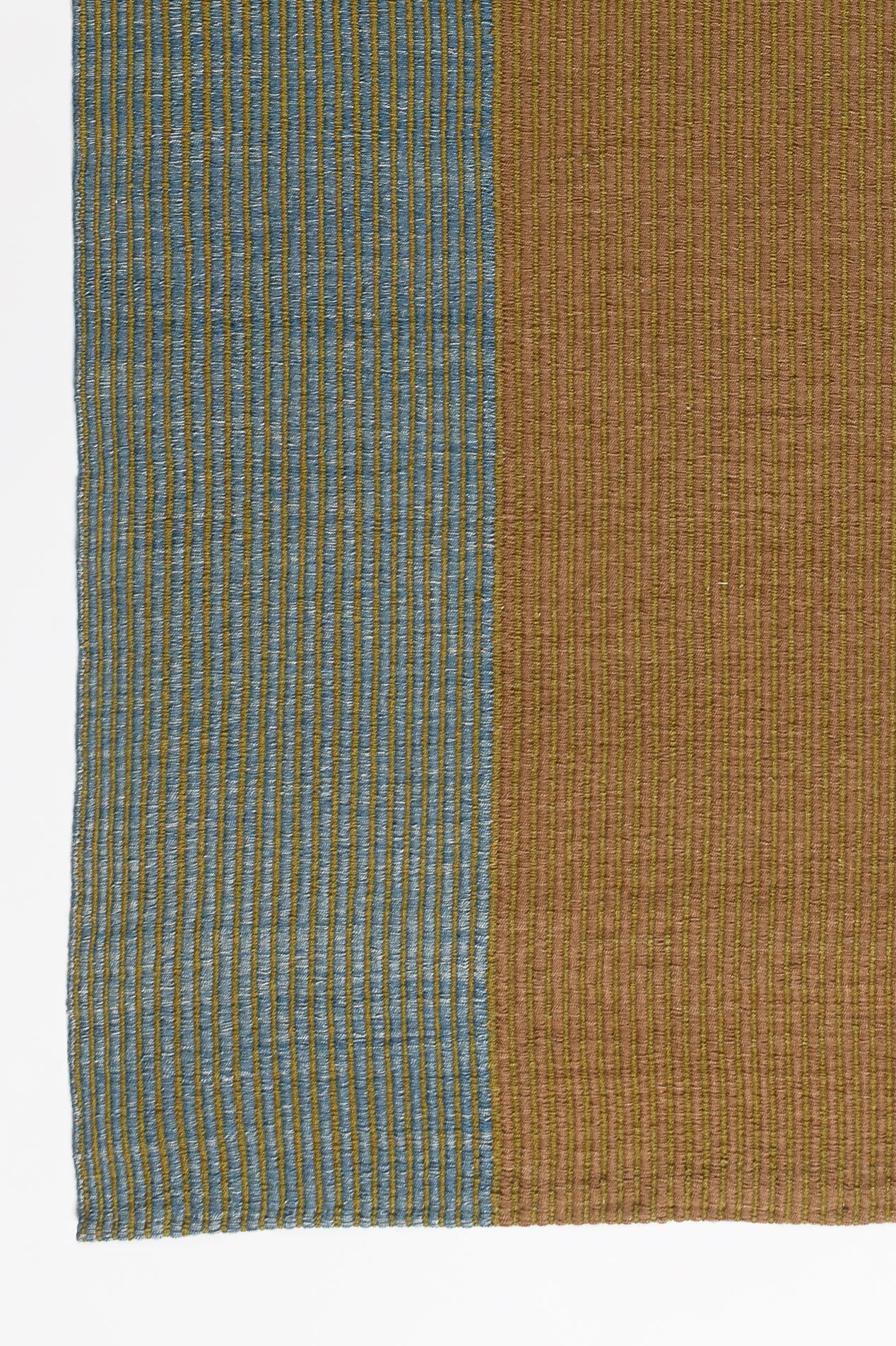 Haze is a contemporary Kilim rug collection inspired by the hazy view of landforms layered behind each other on a misty morning in Tuscany. 

Haze rugs have a unique corduroy texture. The subtle change in the thickness of the cords dissolves the