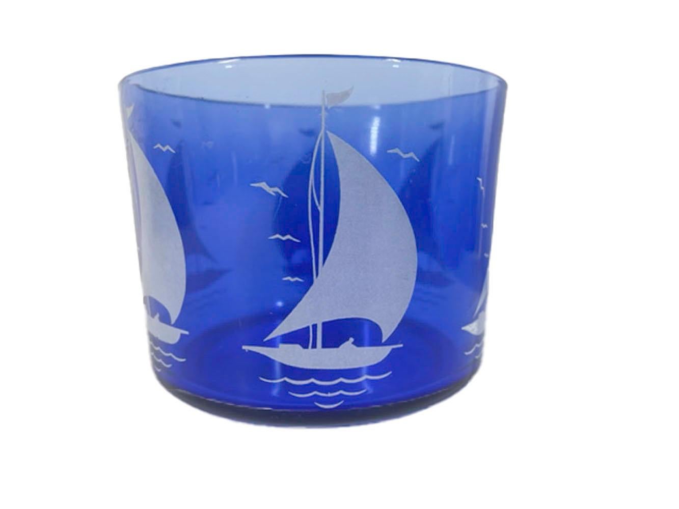 Art Deco cocktail shaker by Hazel-Atlas for their Sportsman Series line. Each piece in cobalt blue glass with white sailboats, the set consisting of a chrome lidded cocktail shaker, an ice bowl and 6 tumblers.