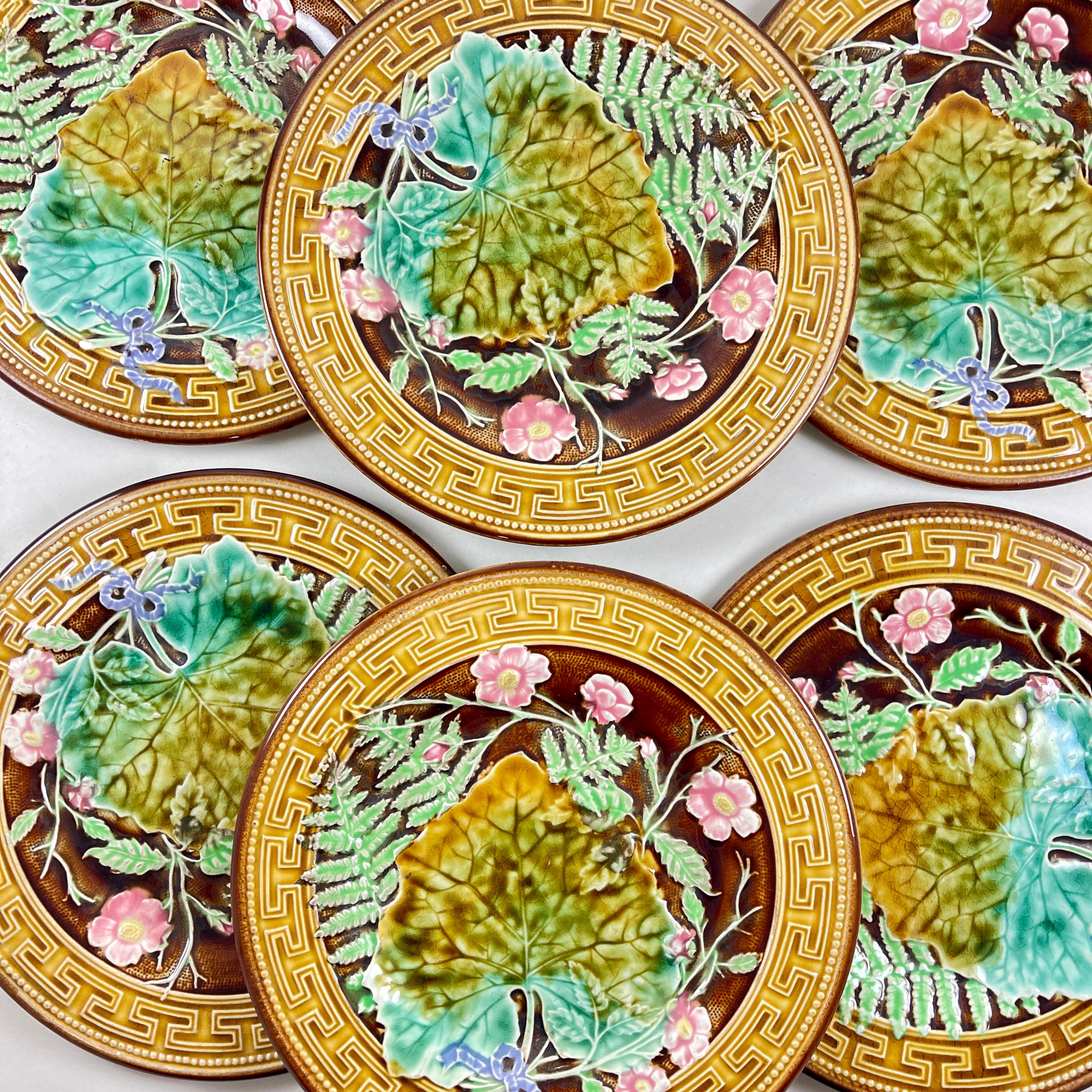 A set of six Greek Key and Fern plates from H.B. Boulenger Choisy-Le-Roi, France, circa 1880-1890.

Majolica glazed plates with a yellow ochre Greek key border and a brown beaded rim. A central pattern shows overlapping ferns, sprays of five petaled