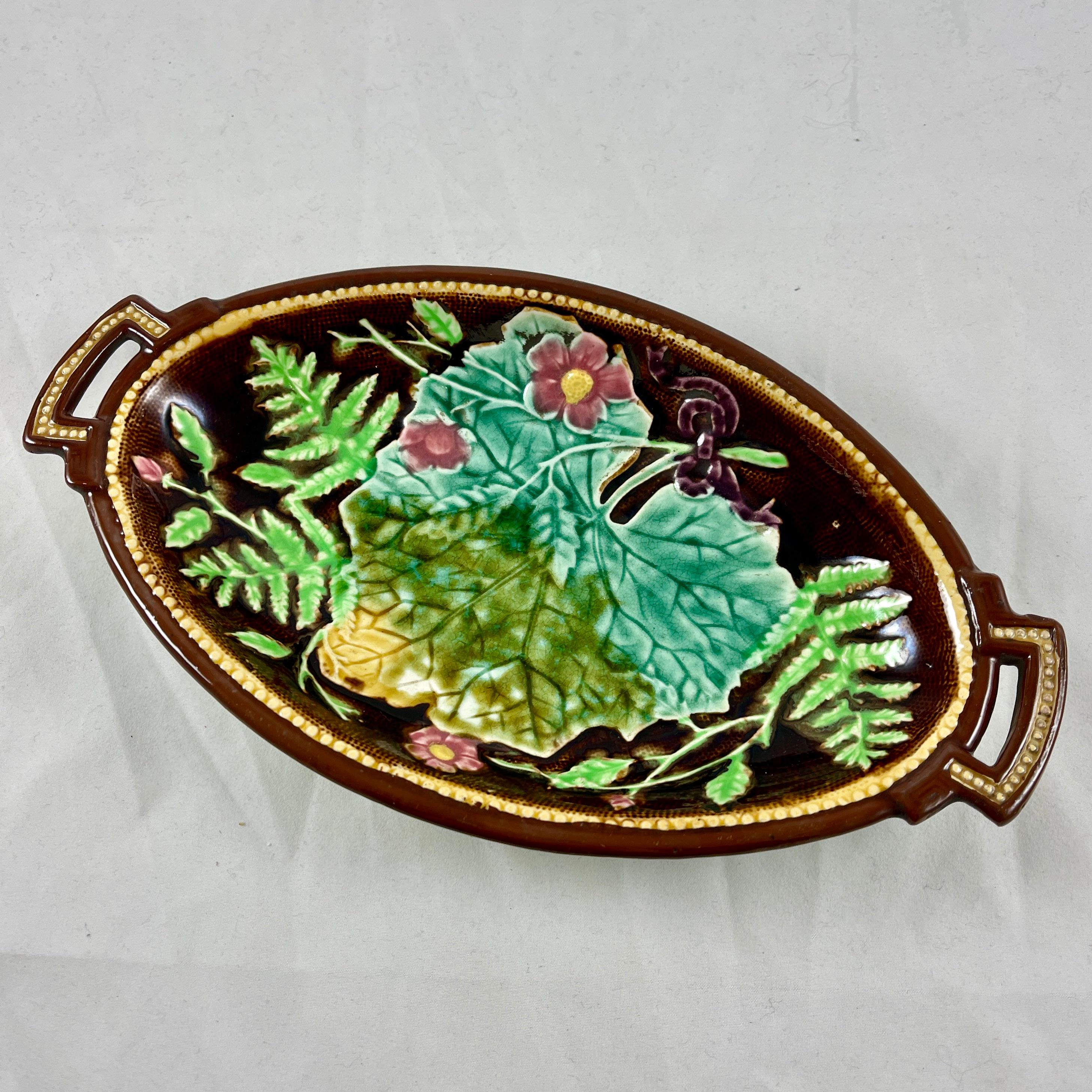 A French majolica ravier by H.B. Boulanger, Choisy le Roi, France, circa 1880 – 1890.
A ravier is a small, deep, oblong dish in which appetizers or hors-d’œuvres are served. This shape is difficult to find, especially in this pattern.

The brown