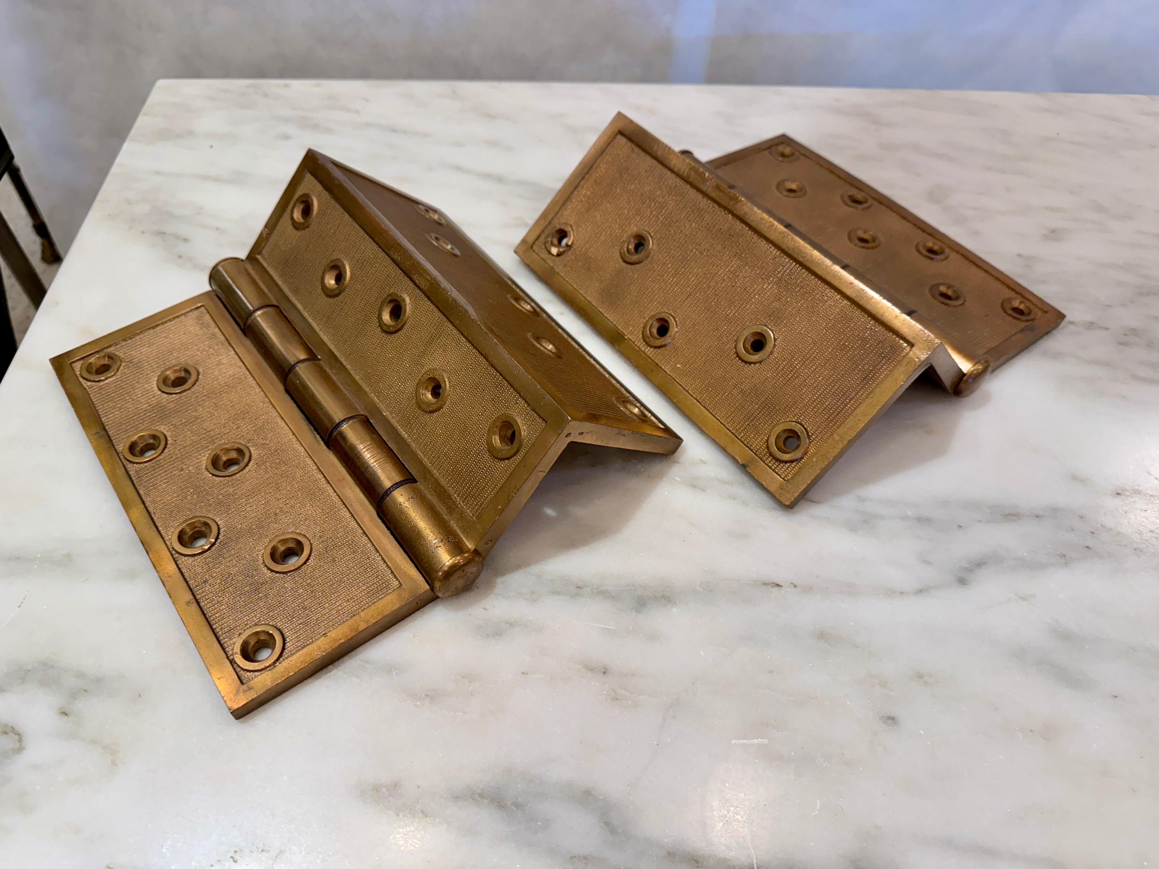 Outstanding and important salvaged bronze door corner hinges, they are stunning simply as an architectural element but can certainly be used for any door needs.  17 total screw holes to each door hinge.  SIGNED - see detail images.