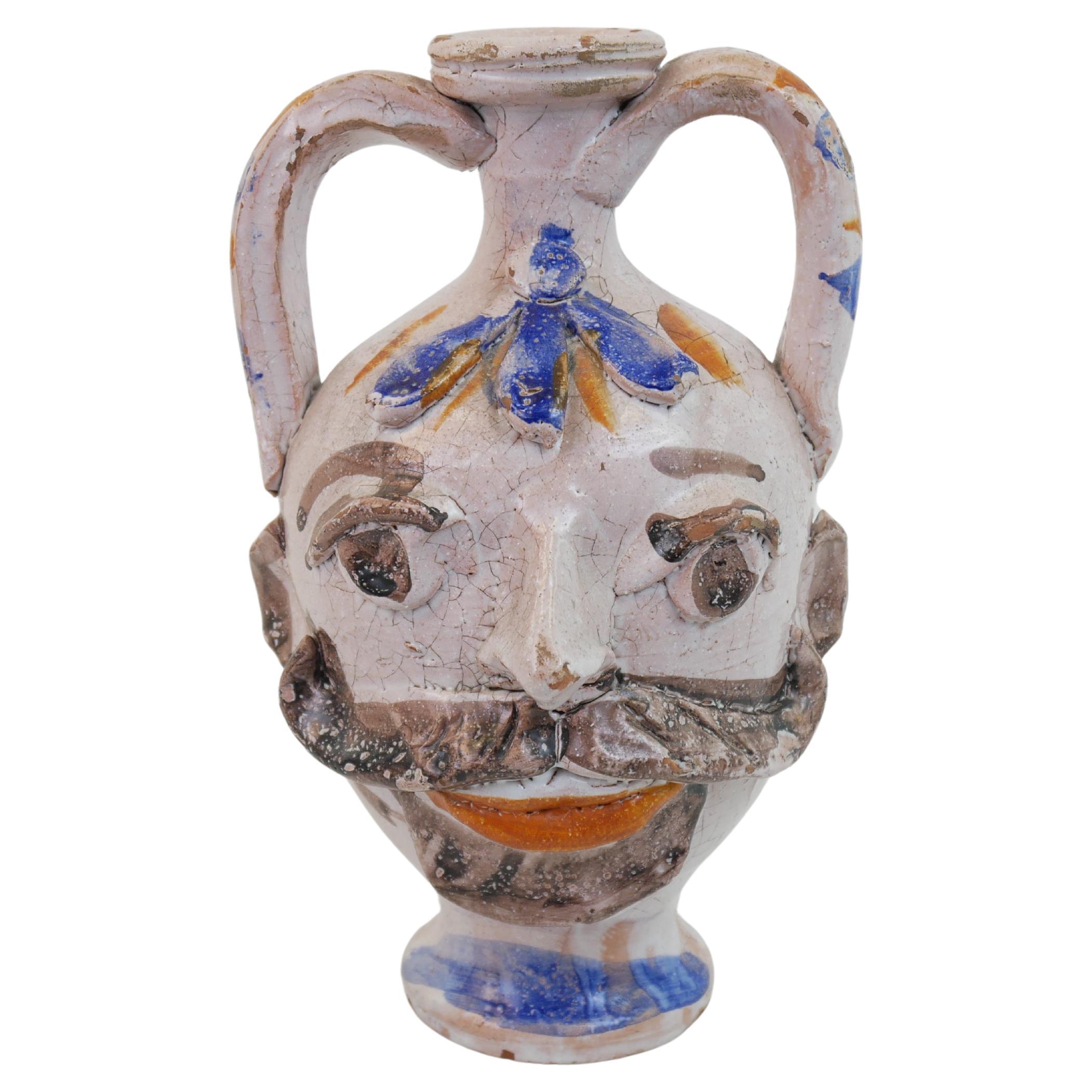 Scultura in ceramica a forma di testa di portacandele