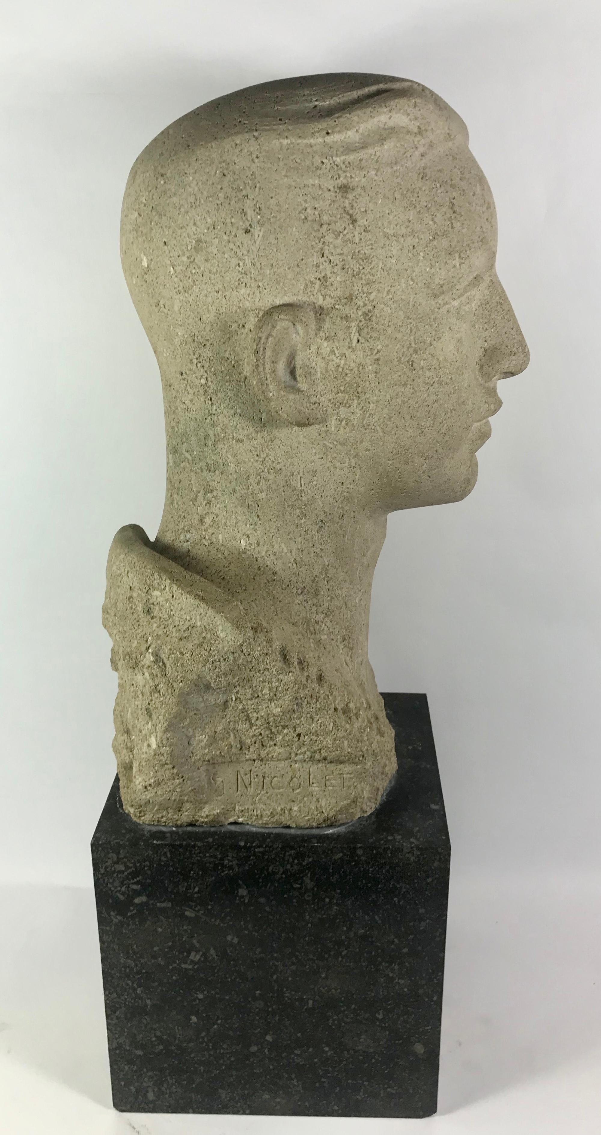 Head of a young man in granite on a black marble statute.
Signed: S. Nicolet.