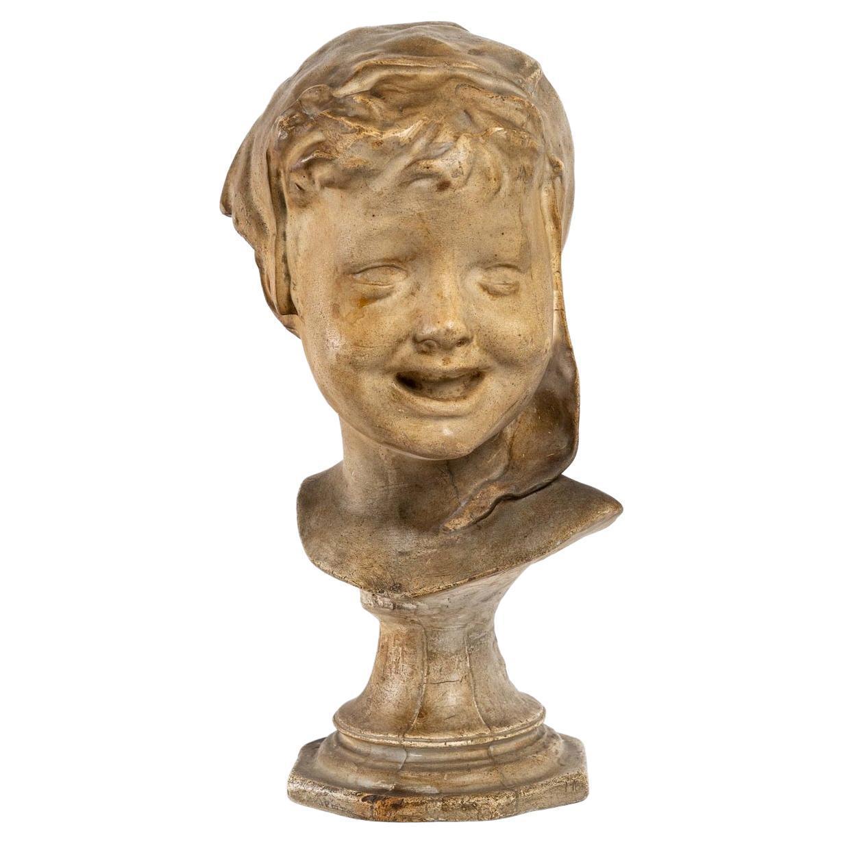 Patinated plaster head of a child, early 20th century, Art Nouveau.
Measures: H: 33 cm, W: 14 cm, D: 18 cm.
 