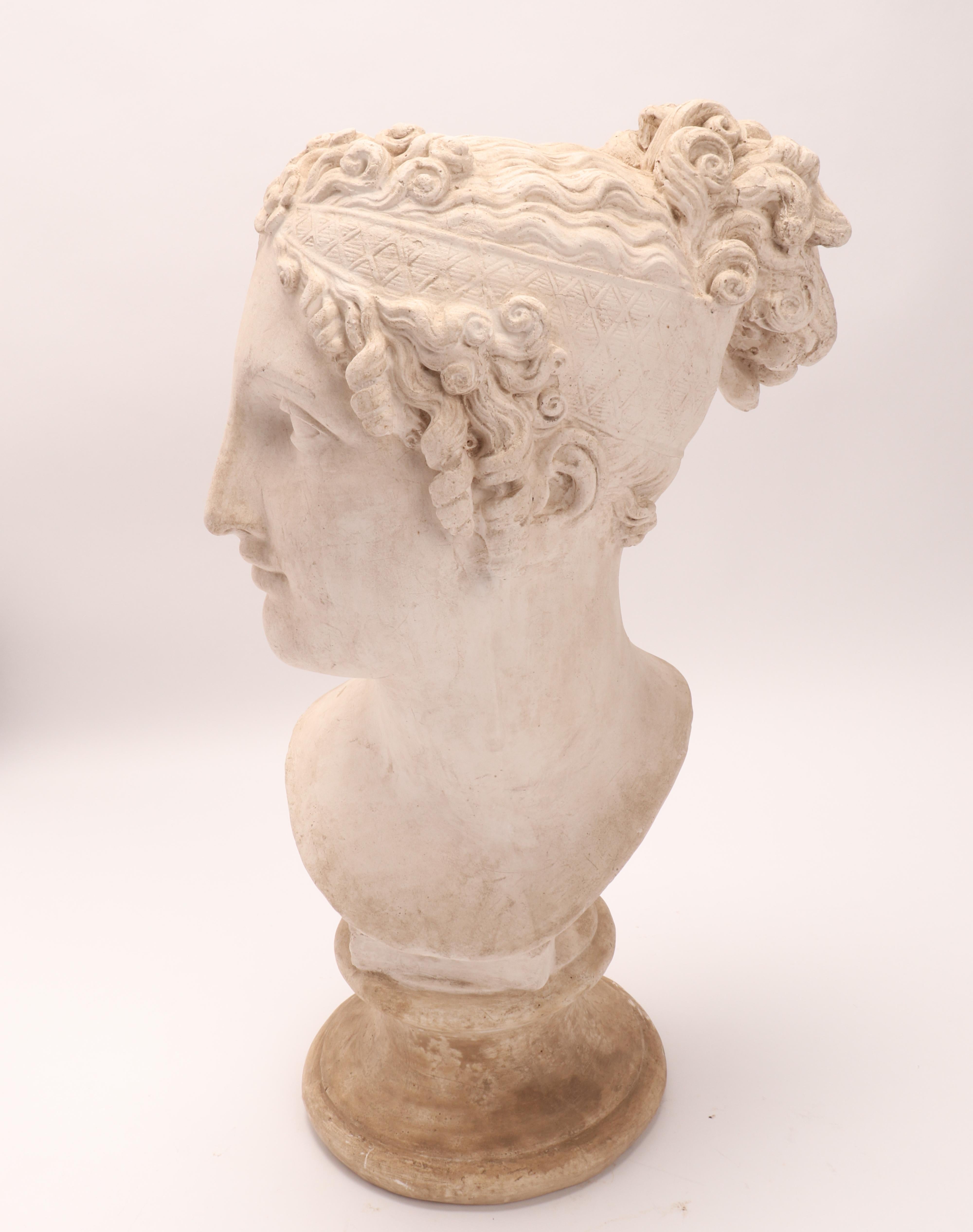 Above the plaster base there is a plaster cast of a woman's head, Neoclassical portrait. A cast for the teaching drawing in the academy. Italy circa 1890.