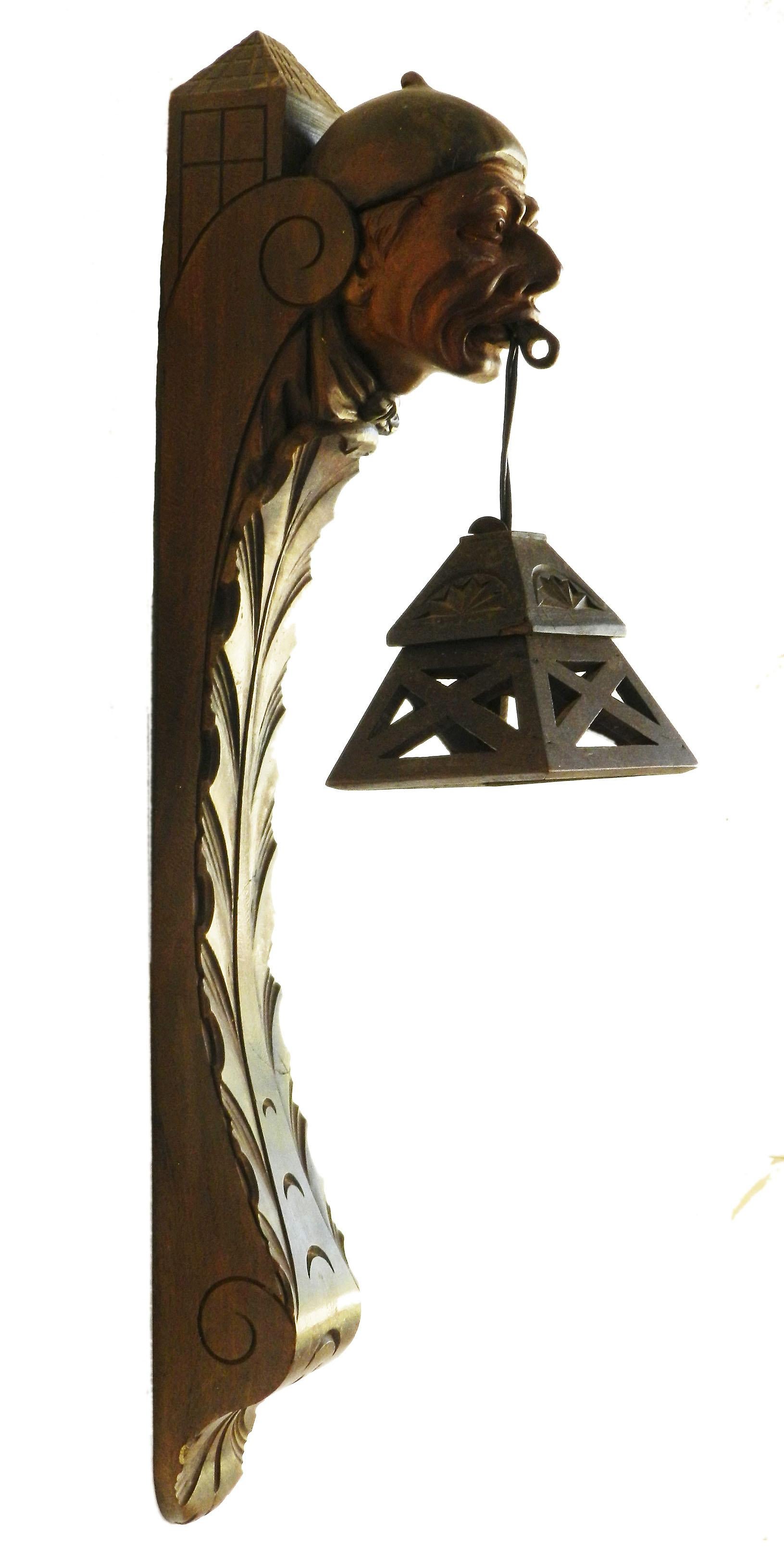 Wall sconce lantern French basque sculpted wood head c1920
Unusual head light
Gothic revival Folk Art
In good original condition 
This will be re-wired and tested to USA or UK and European standards ready to install.
Free Shipping to USA, EU, UK