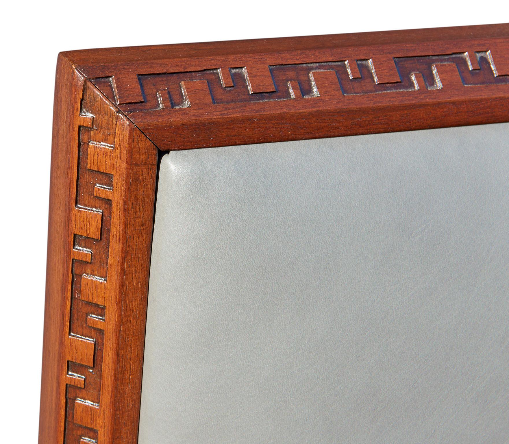 Designed by Frank Lloyd Wright for Henredon in 1955, this rare headboard for a king-size bed is made of solid African mahogany, its edges carved with Wright's distinctive Taliesen 