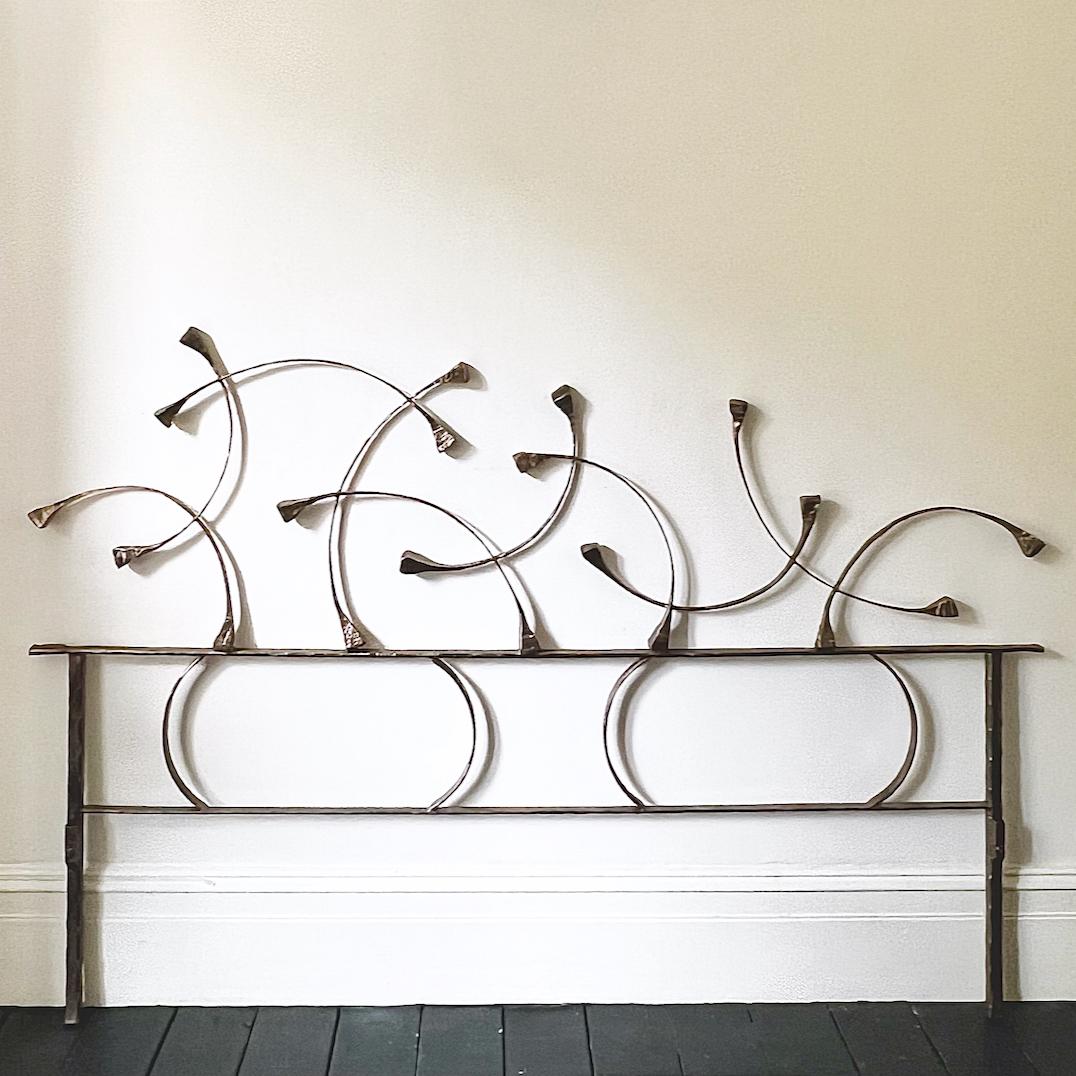 A sculptural headboard of hand-forged metal with powder coloured pigments. A beautifully wrought abstract work by Italian craftsman Salvino Marsura, 1970s.

The headboard is all one piece, with tubes to the front of the legs where further bed frame