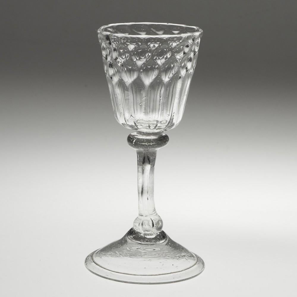Heading : Set of four Liege wine glasses
Period : c1720
Origin : Liege
Colour : Clear
Bowl : Round funnel with a band of straberry moulding above rim moulding
Stem : Annular collar, flattened ball cushion, large air tear
Foot : Folded conical
Pontil