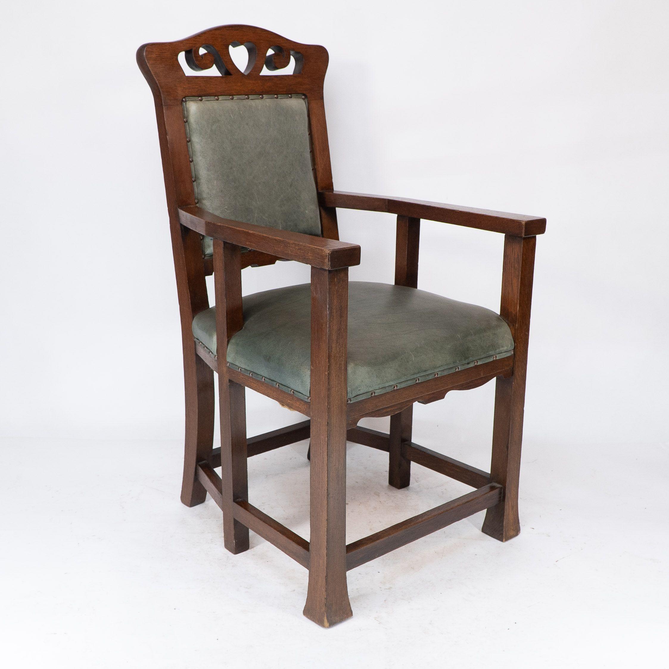 Heal and Son, attributed. An Arts and Crafts six-legged oak armchair, with pierced heart and scroll decoration to the head rest. Professionally re-upholstered in green leather.
Seat Height: 52 cm
Arm Height: 74 cm