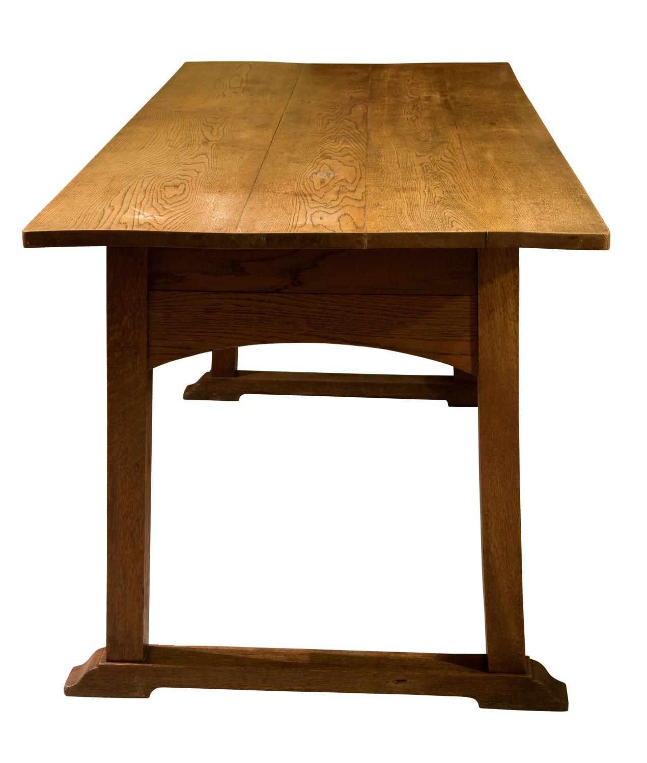 An arts and crafts oak refrectory dining table 