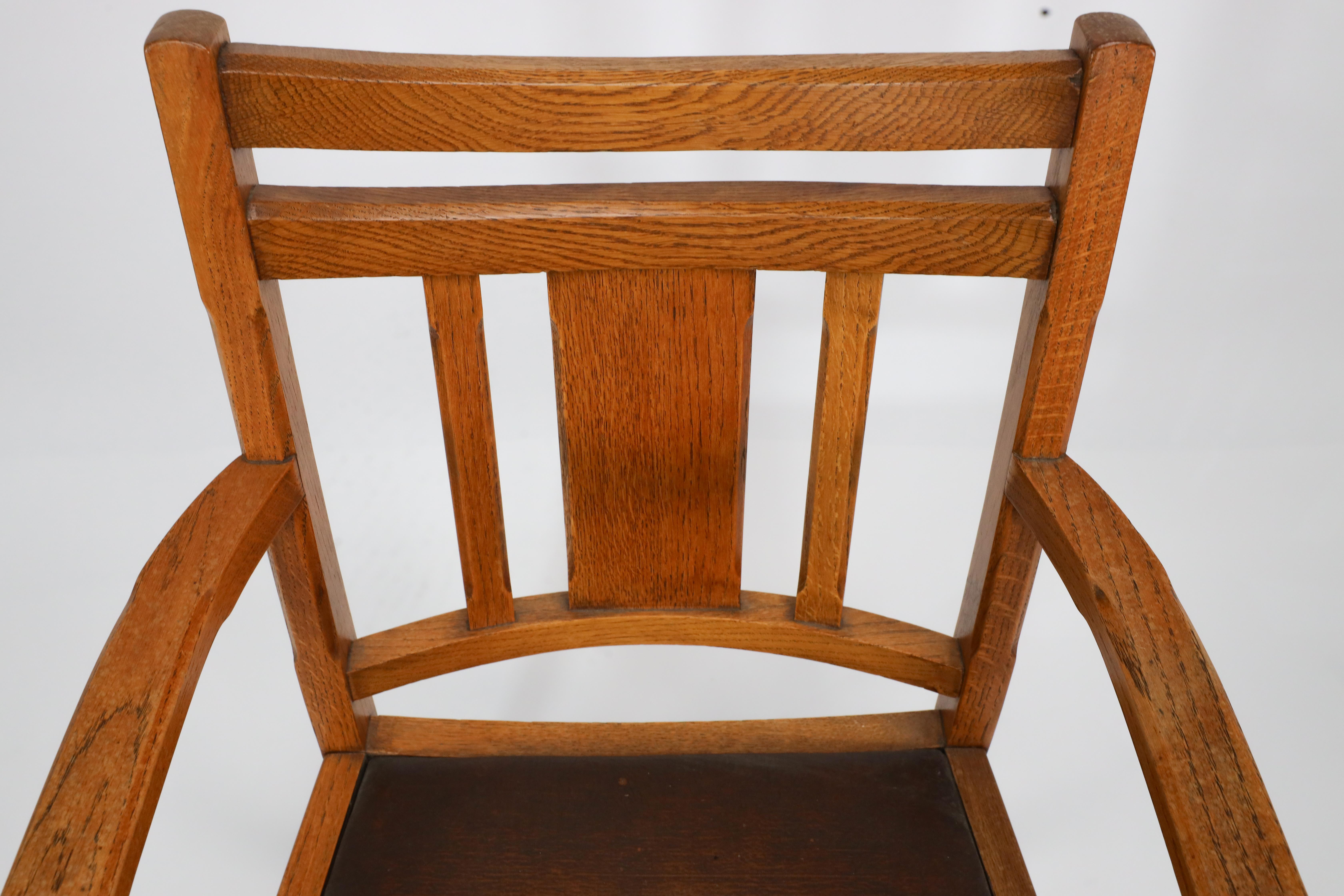 Mid-20th Century Heals. A good quality Arts and Crafts oak armchair with chamferred details For Sale