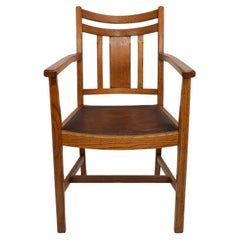 Heals. A good quality Arts and Crafts oak armchair with chamferred details