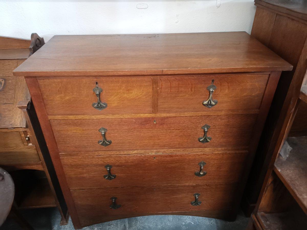 Heals. An Arts and Crafts oak chest of drawers, stamped Heals of London.