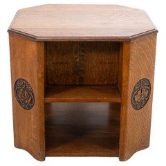 Heals. An Arts & Crafts octagonal oak bookcase/side table with carved decoration
