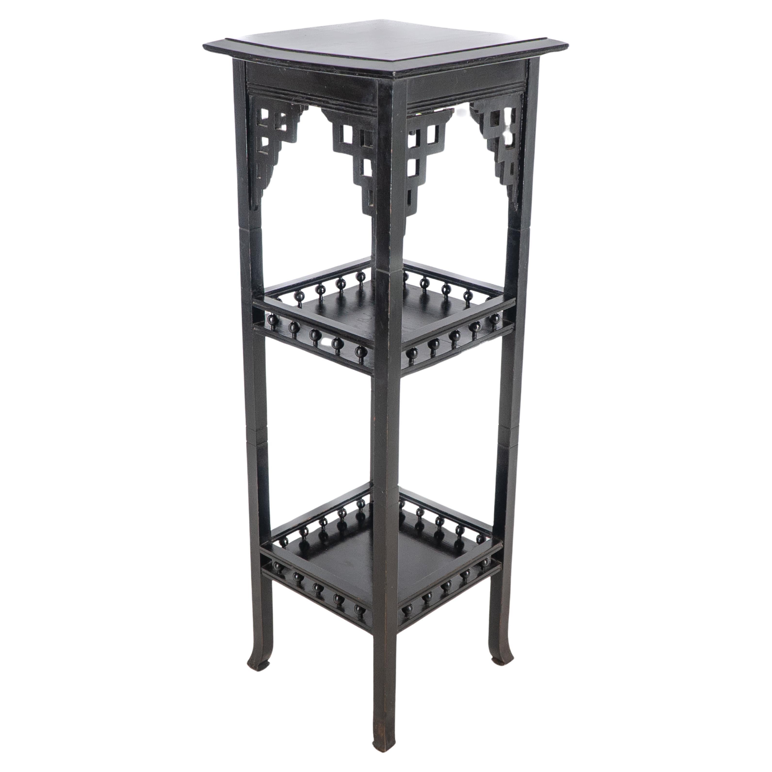 Heals attributed. An Anglo-Japanese Aesthetic Movement three tier ebonized stand