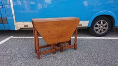 Heals, Attributed, An English Arts & Crafts Oak Drop Leaf Hexagonal Dining Table