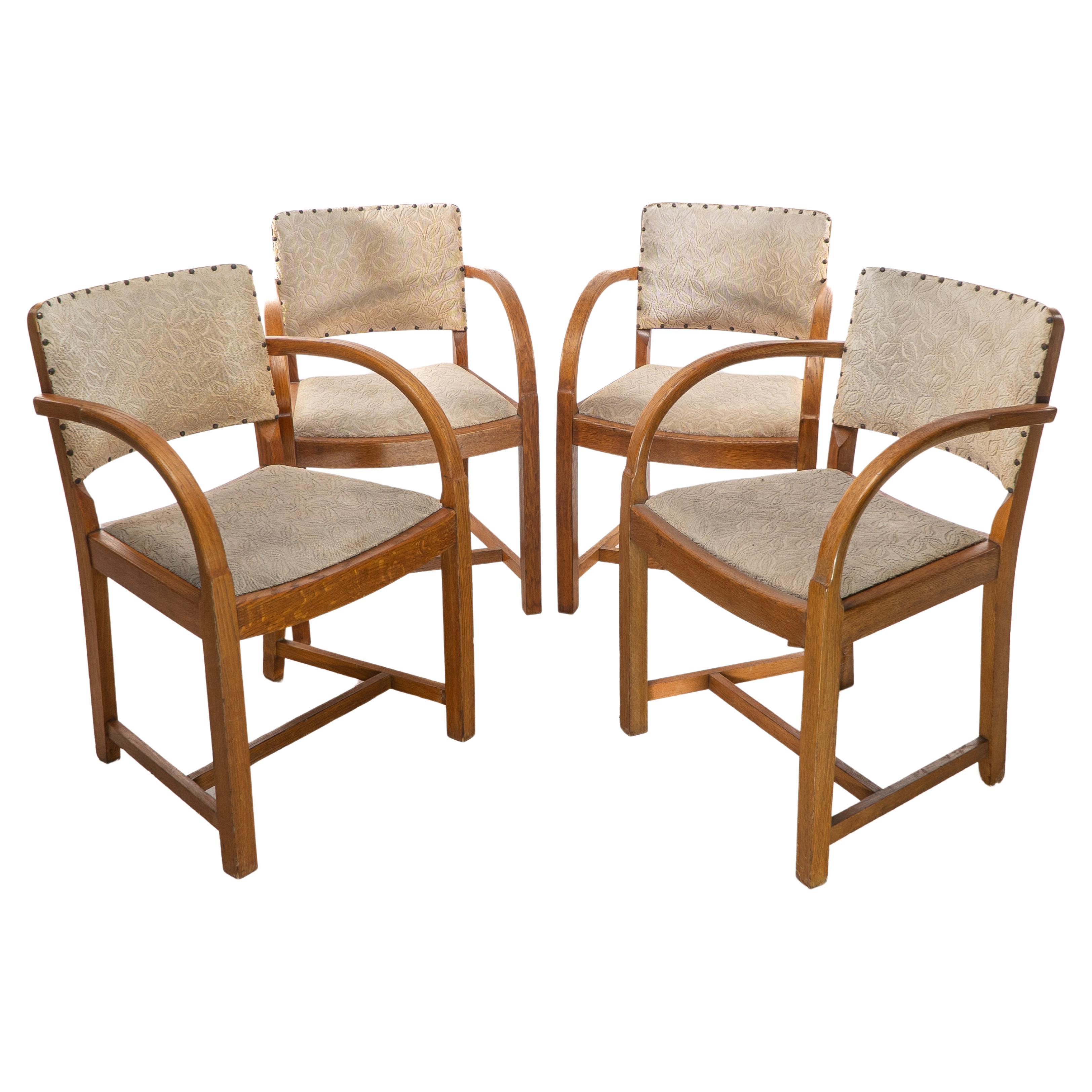 Heals. Four Art Deco oak armchairs with shaped backrests & rounded arms