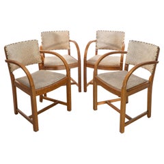 Antique Heals. Four Art Deco oak armchairs with shaped backrests & rounded arms