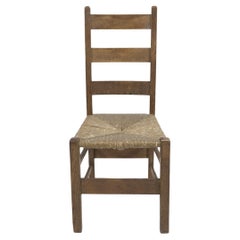 Heals. London. An Arts and Crafts ladderback with original rush seat