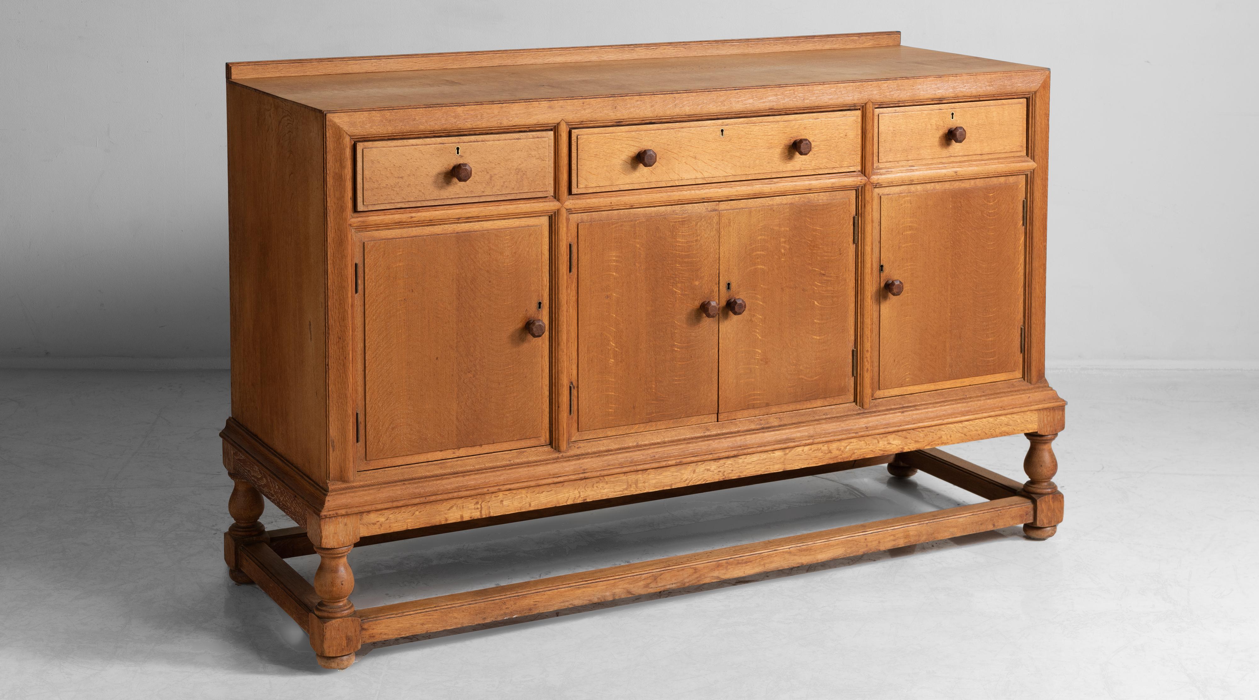 Heal’s oak sideboard, England, circa 1920.

Constructed from quality oak timbers, with inset Heals Maker label and original key. The piece is also stamped by the cabinet maker, J. Pemberton.