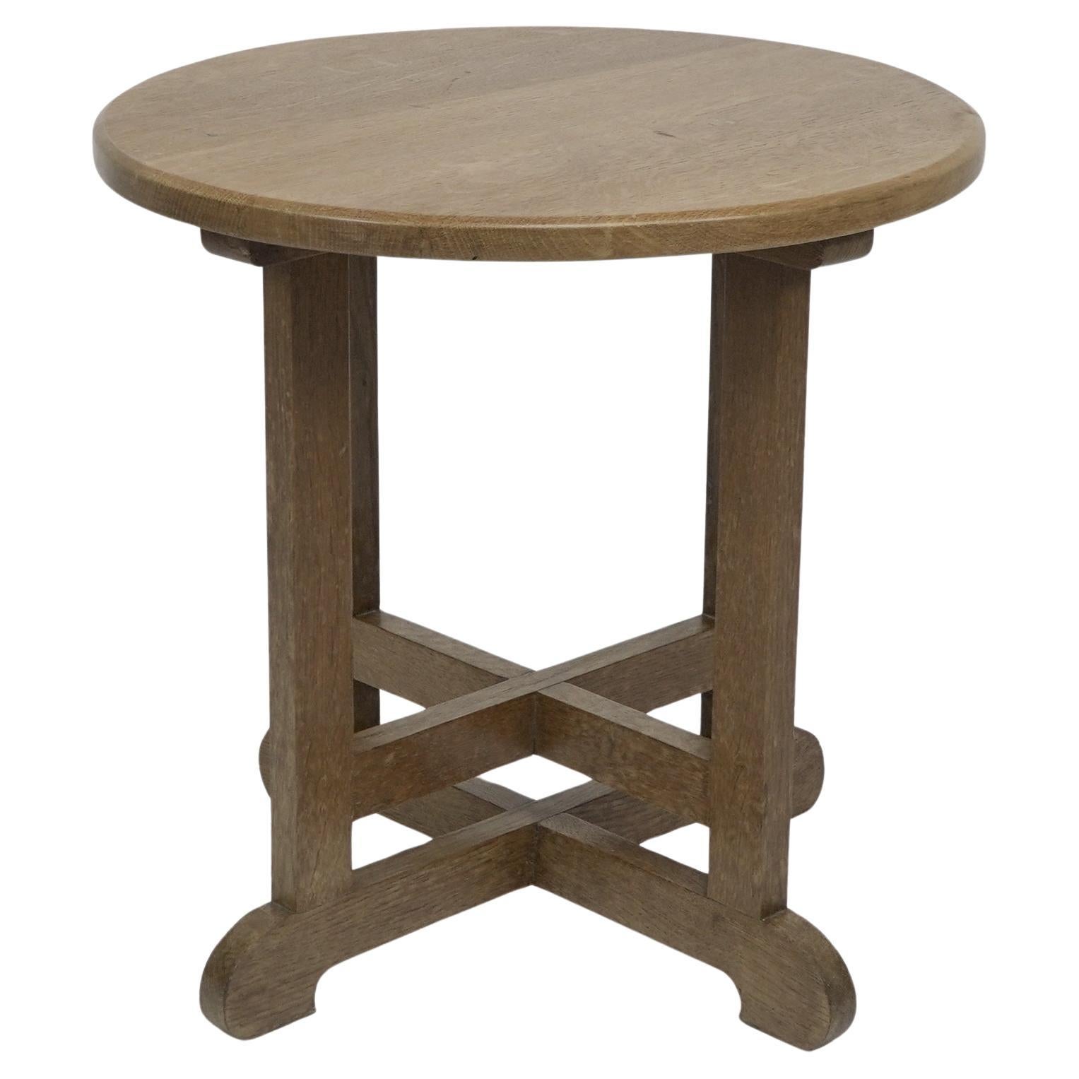 Heals of London in the style of. An oak circular oak side or occasional table.