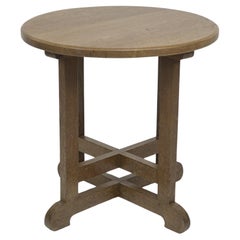 Antique Heals of London in the style of. An oak circular oak side or occasional table.