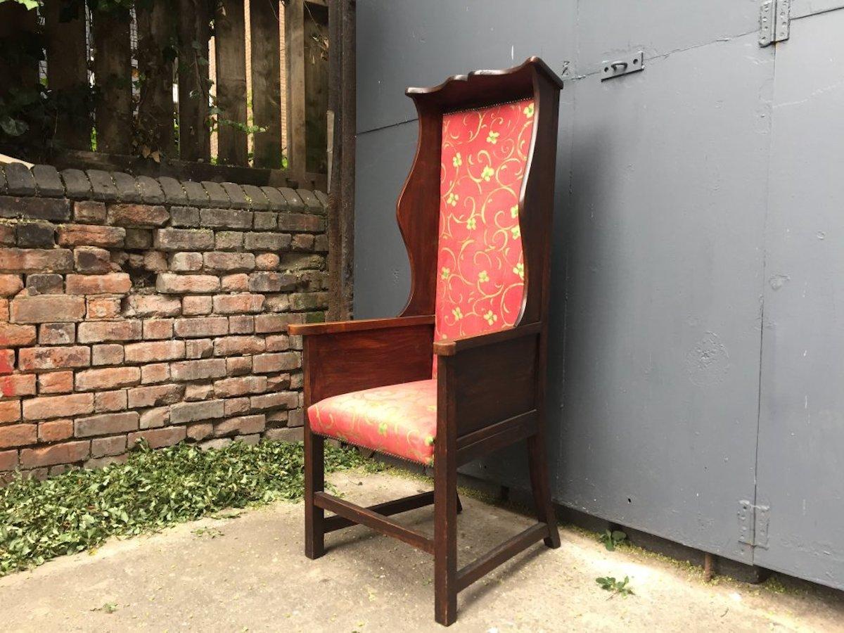 Heals of London attributed. 
An Arts & Crafts oak high back wing back or Porter's armchair with shaped cornice and shaped elongated wings to the sides to keep the draughts away from the porter.