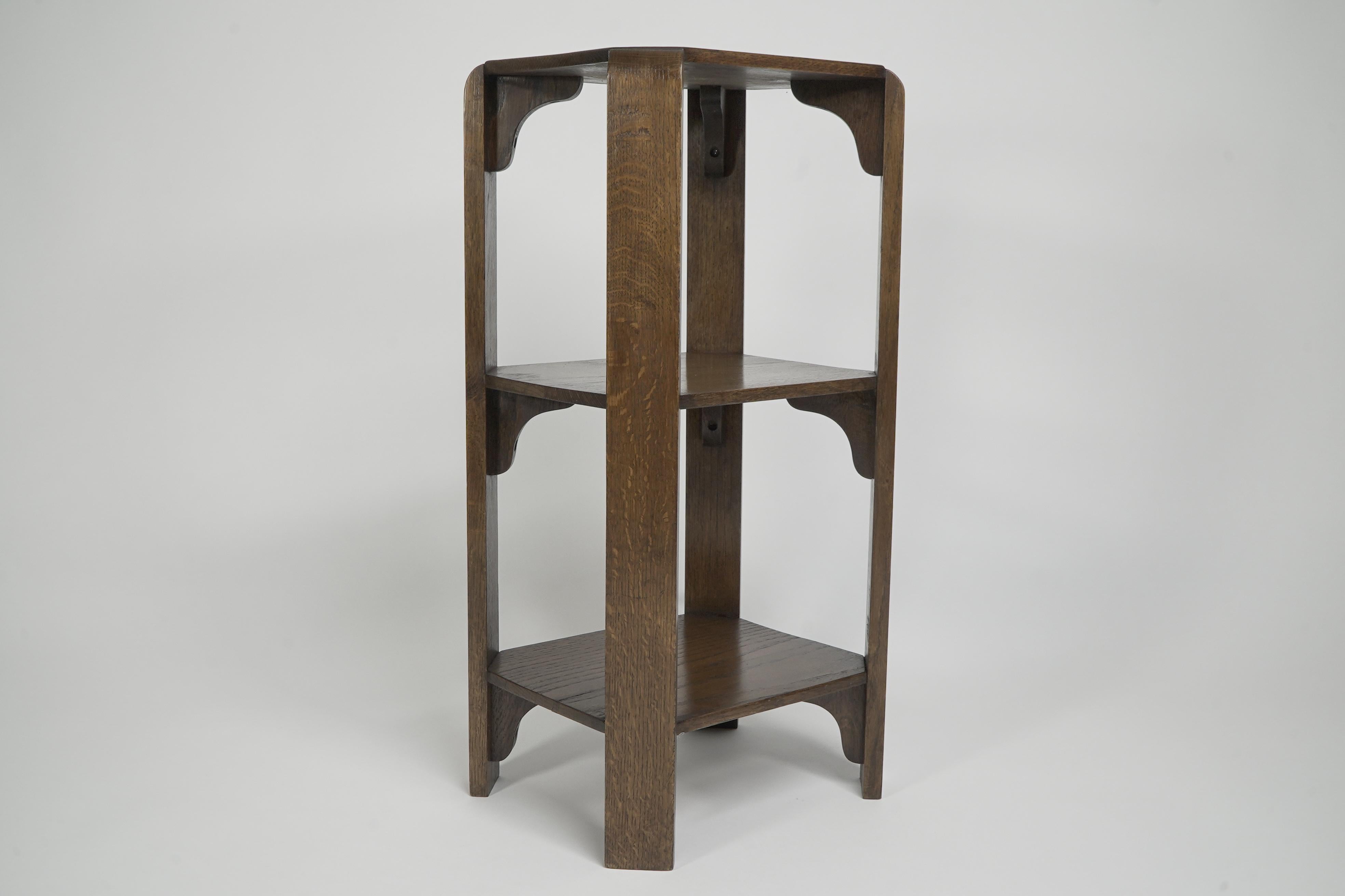 Oak Heals of London (attributed). A late oak three tier book table or wotnot For Sale