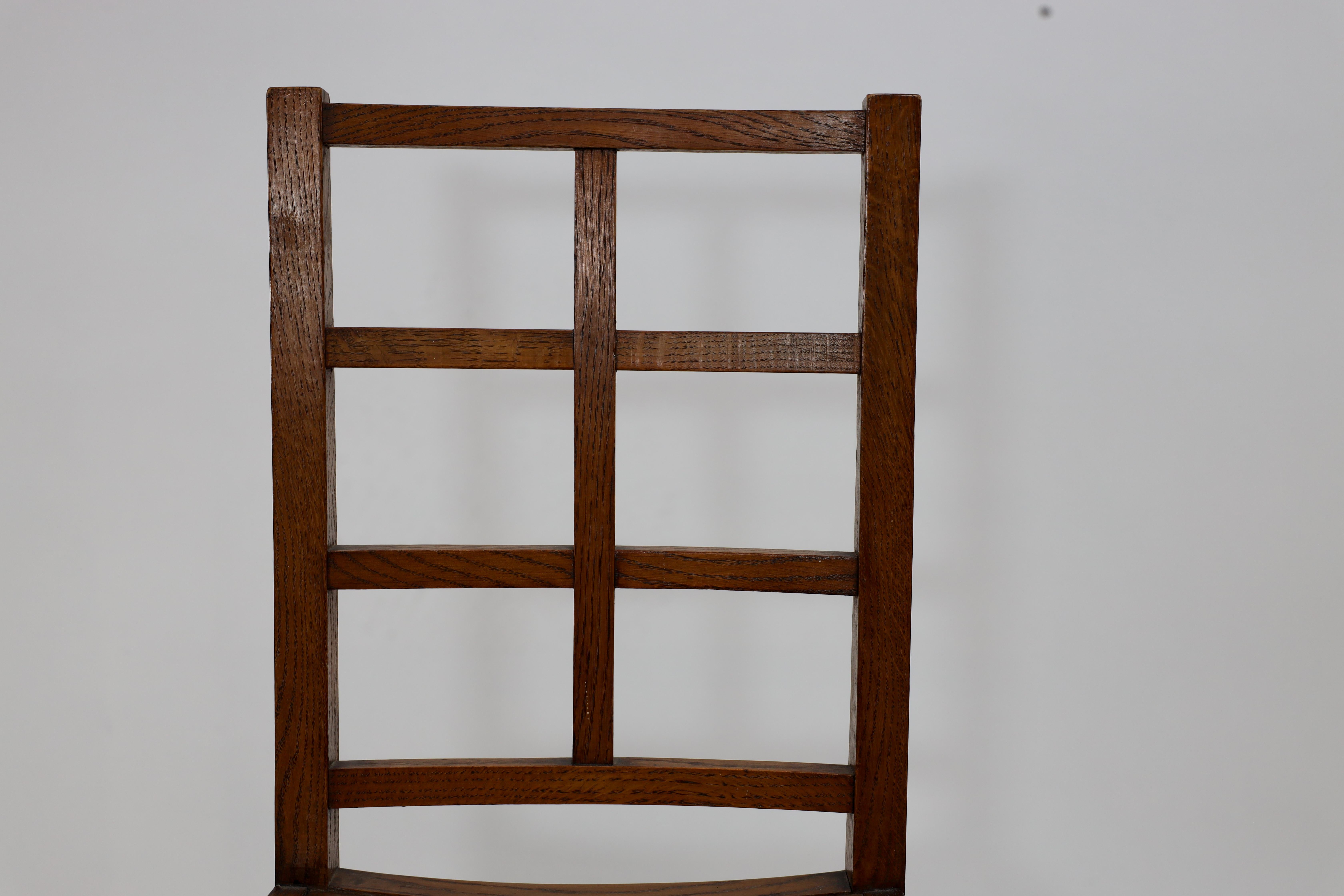 Oak Heals of London, attributed. An Arts & Crafts oak lattice back side chair For Sale