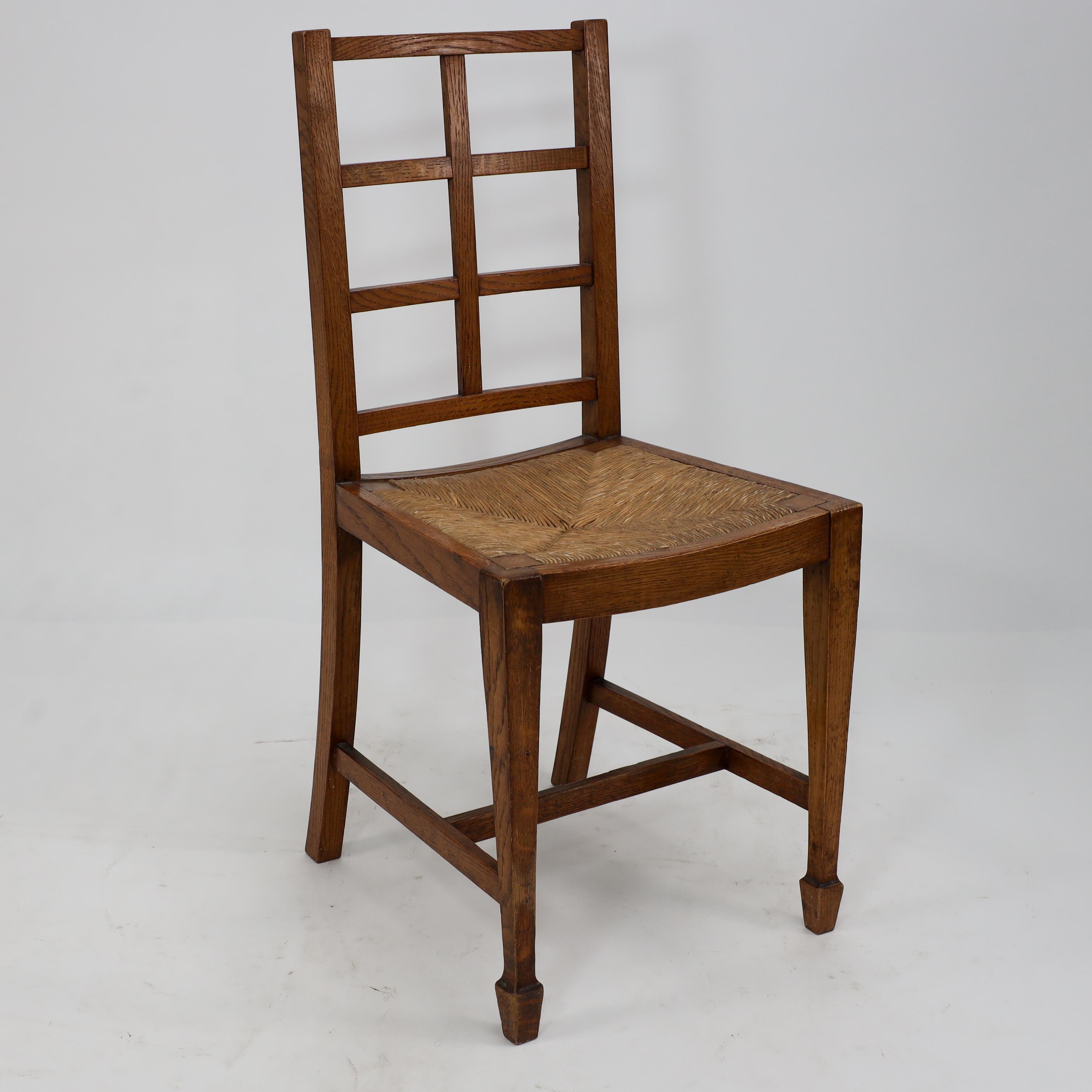Heals of London, attributed. An Arts & Crafts oak lattice back side chair with a nice original, drop in rush seat.