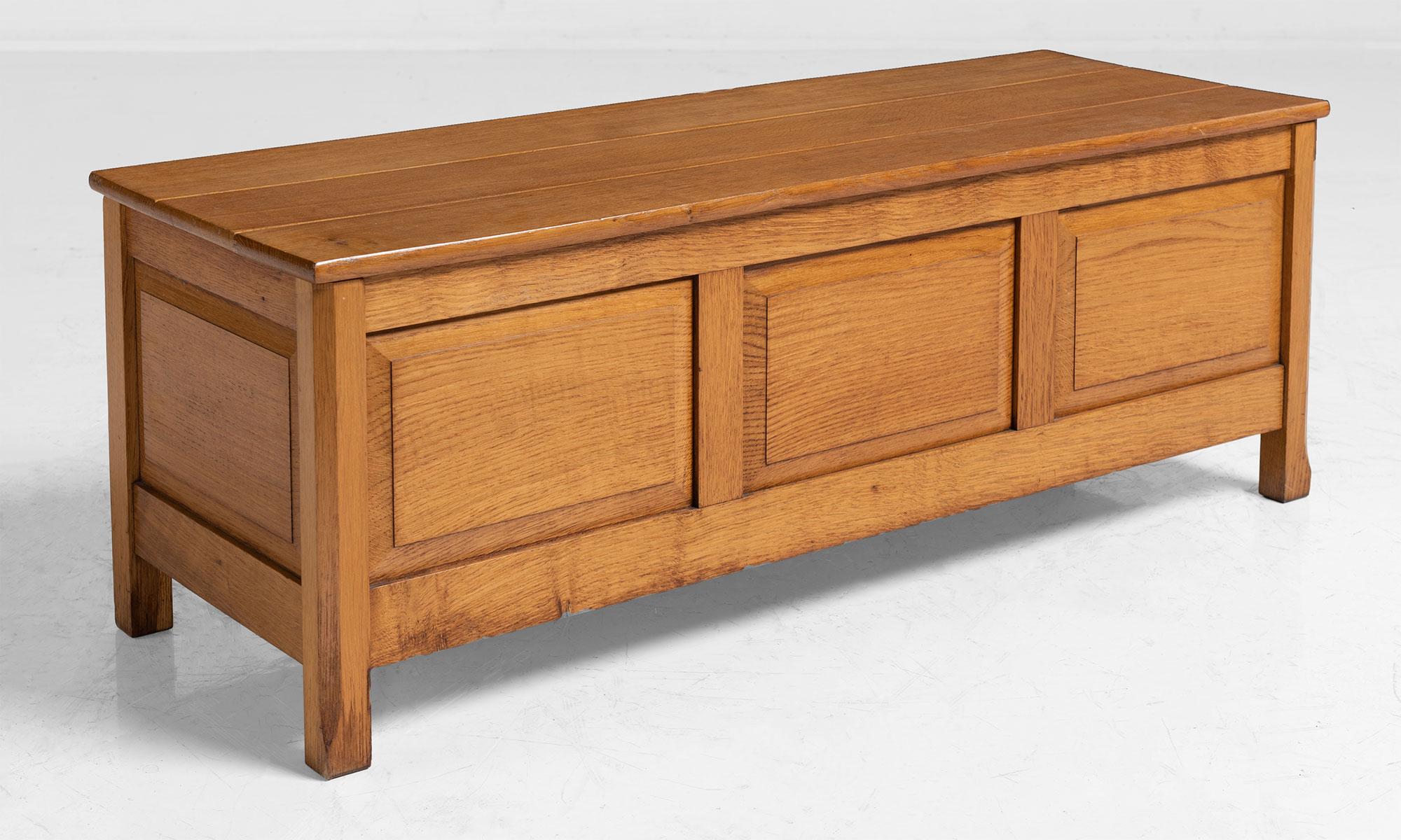 Oak blanket box made by Arthur Reynolds in the Cotswold Style for Heals of London. Paneled front and sides in original finish.
  