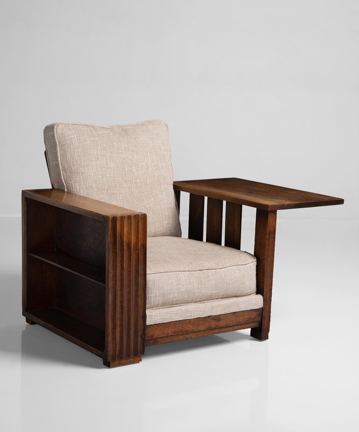 Heals of London oak reading armchair, England, circa 1920.

Large, comfortable armchair with a classic design by Heals of London. Newly upholstered in neutral fabric, with oak frame and fold down table.
