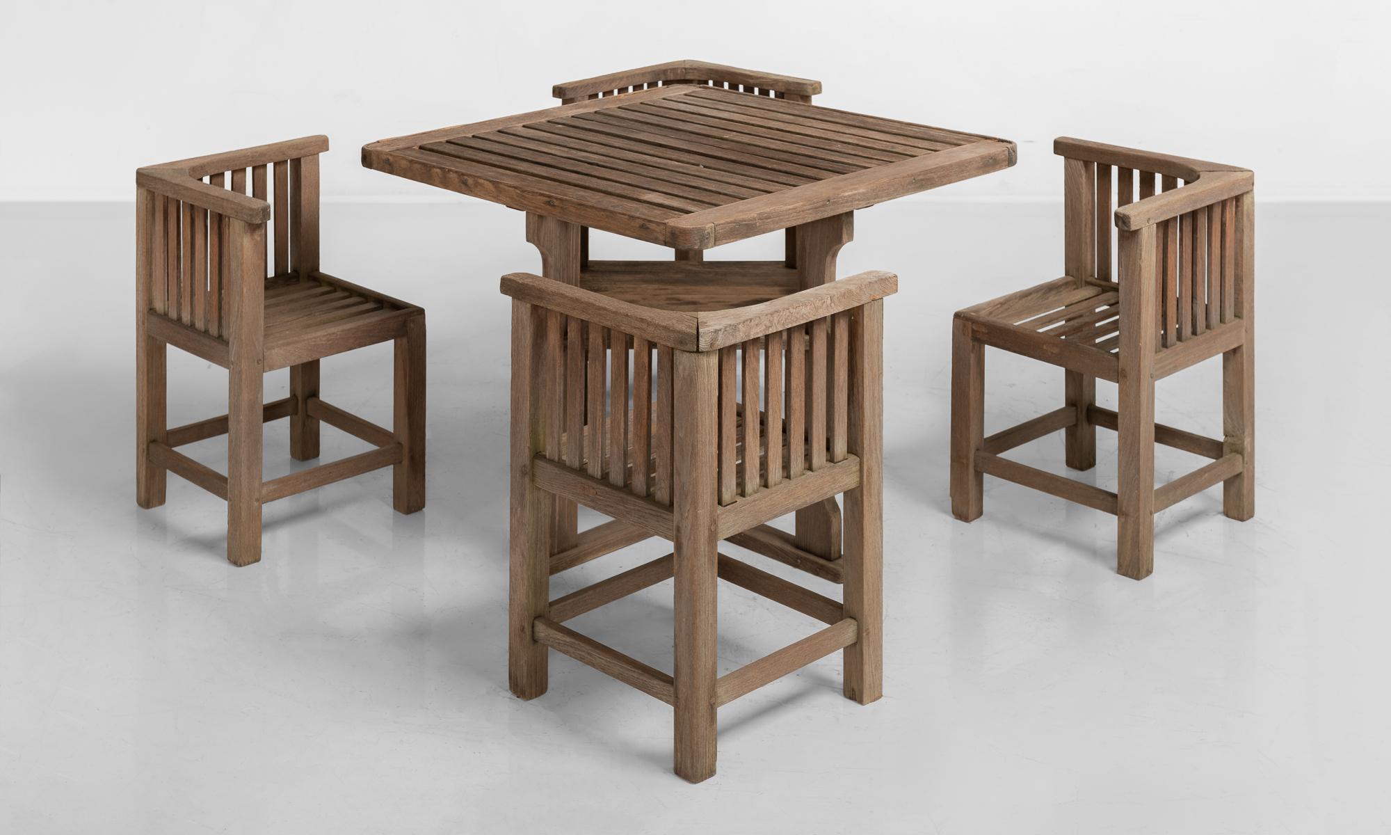 Heals of London teak garden set, England, circa 1930.

Slatted teak outdoor dining table with four dining chairs.

Measures: Table 36” W x 36” D x 28” H
Chairs 16” W x 16” D x 26” H x 15.25” Seat.
 